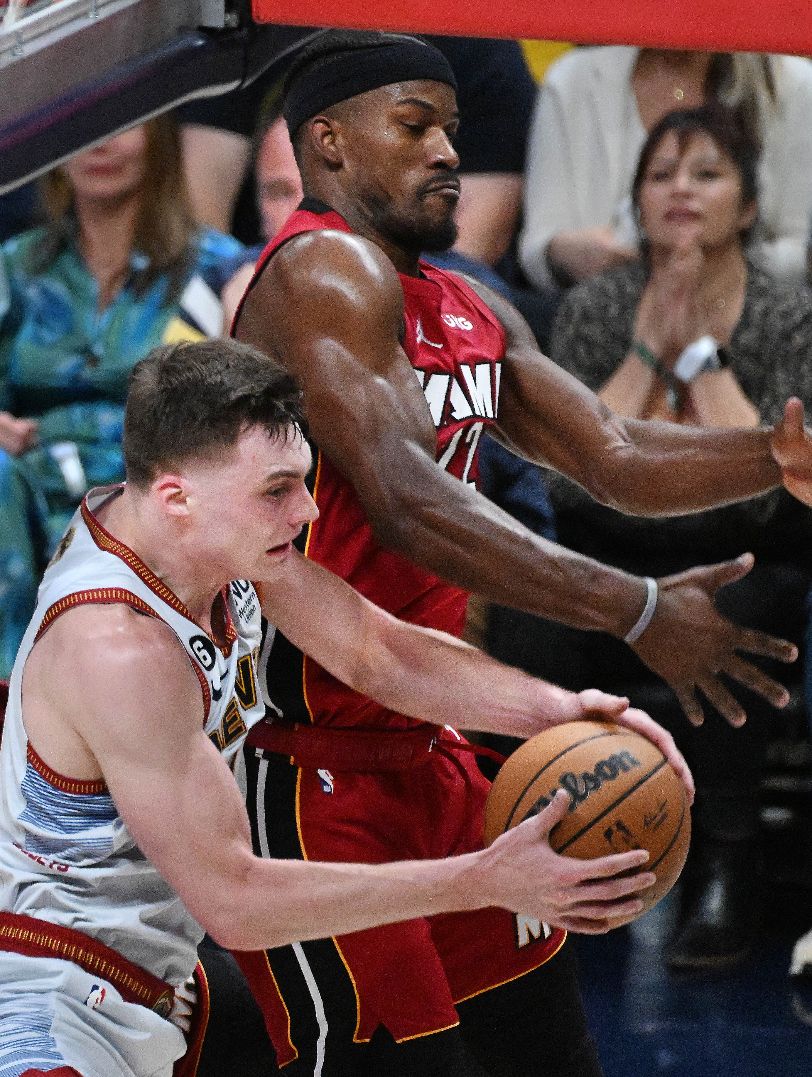 Denver Nuggets guard Christian Braun (0) grabs on offensive rebound while being defended by Miami Heat forward Jimmy Butler (22) during the 2nd quarter of game 5 of the NBA Finals at Ball Arena on Monday, June 12, 2023. (Photo by Jerilee Bennett, The Gazette)061323-s-dg-nuggets-game5 6723.jpg