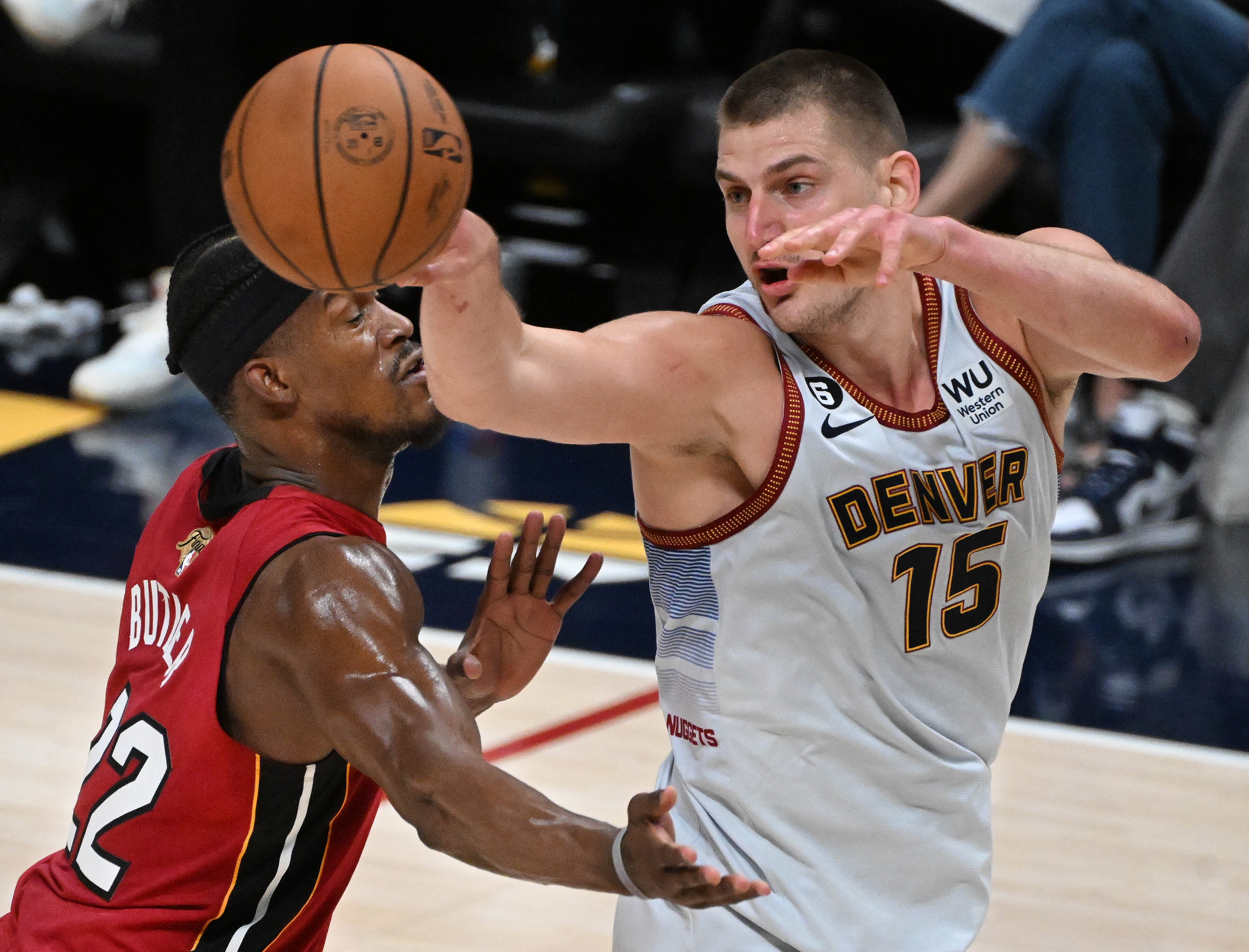 Denver Nuggets center Nikola Jokic (15) passes the ball past Miami Heat forward Jimmy Butler (22) during the 2nd quarter of game 5 of the NBA Finals at Ball Arena on Monday, June 12, 2023. (Photo by Jerilee Bennett, The Gazette)061323-s-dg-nuggets-game5 6888.jpg
