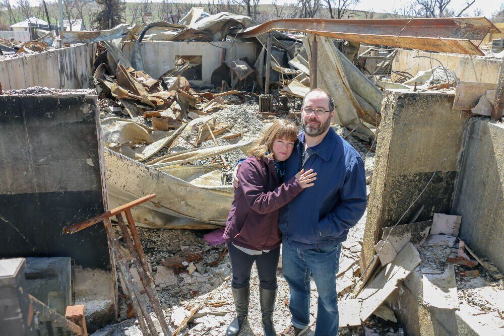 FILE PHOTO: Kelly Watt and Phil Rosenberg-Watt stand in the remnants of their Superior home. In response to the fire’s destruction, residents in the eastern grassland area of unincorporated Boulder County must now follow new building regulations requiring them to use ignition-resistant materials before they build new homes. (JohnMooreSenior Arts Journalistjohn.moore@denvergazette.comhttps://denvergazette.com/content/tncms/avatars/e/1e/bc8/e1ebc854-8dbc-11ec-90b8-e393b5c0a2b9.afcf882df81bc4eba7366657cc603f75.png)