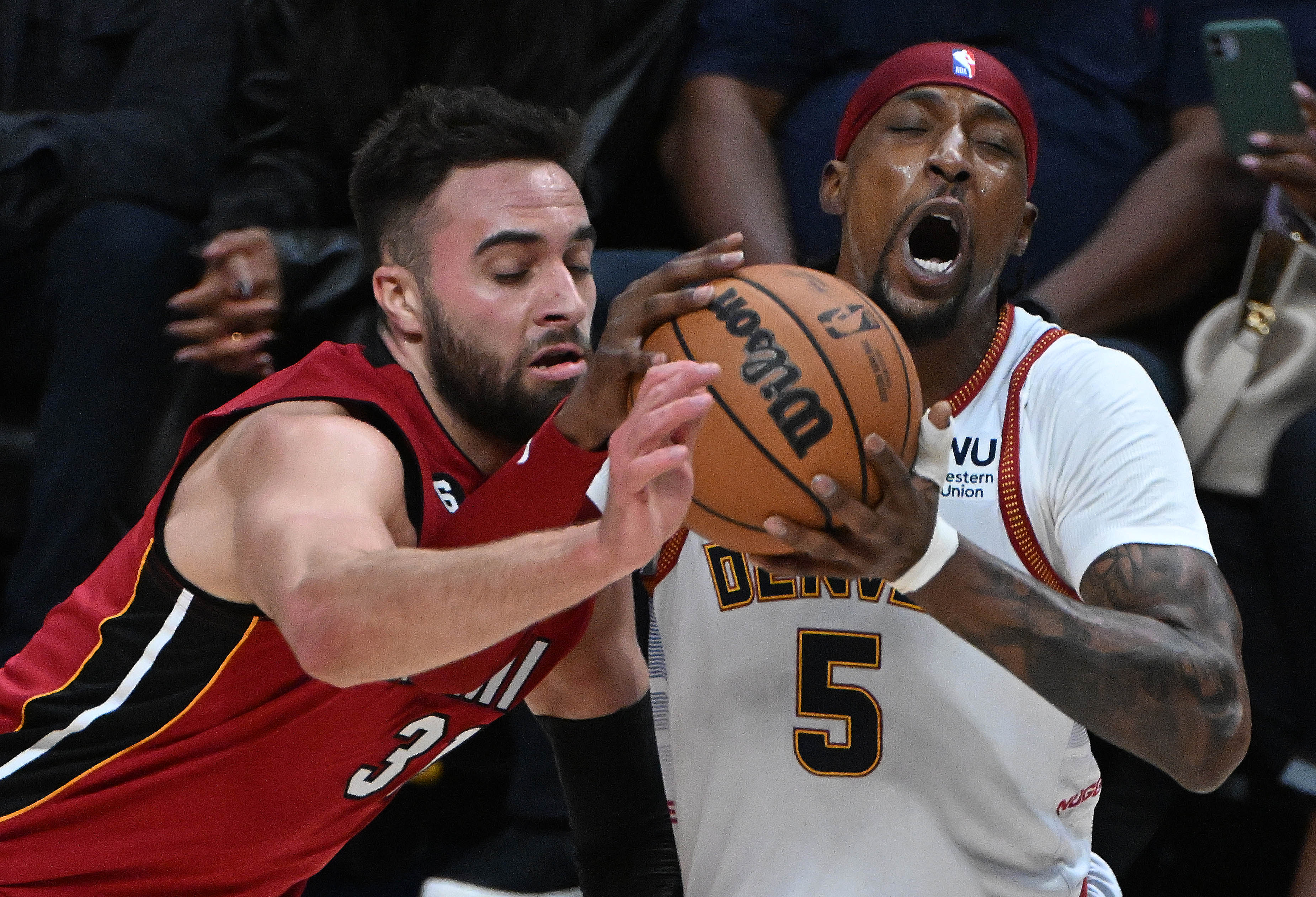 061323-s-dg-nuggets-game5 3085.jpgDenver Nuggets guard Kentavious Caldwell-Pope (5) is pressured by Miami Heat guard Max Strus (31) during the first quarter of Game 5 of the NBA Finals at Ball Arena on Monday. (Jerilee Bennett, The Gazette)