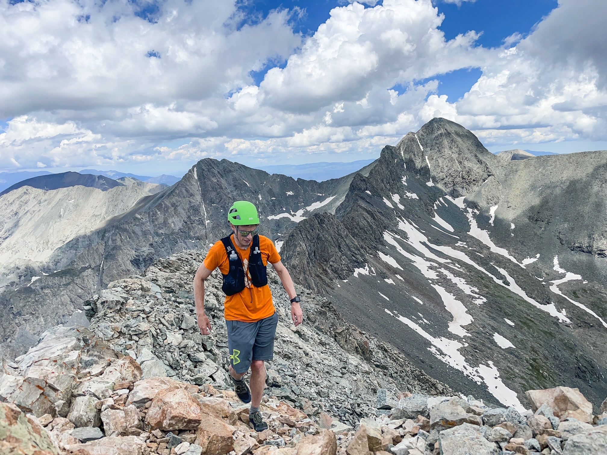 Spencer McKee on the summit of Little Bear Peak, with Blanca Peak and Ellingwood Peak in the background. Photo Courtesy: Spencer McKee