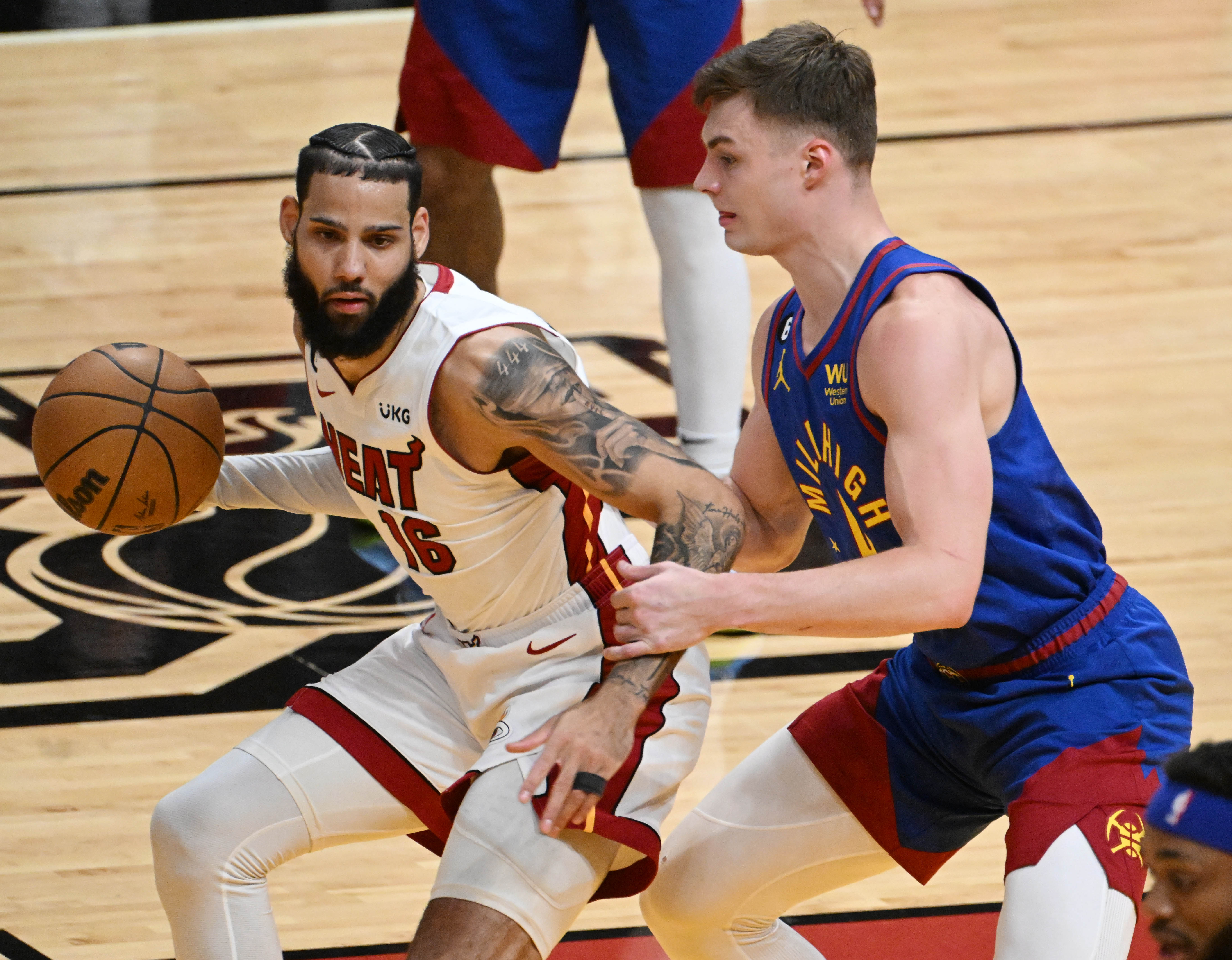 Miami Heat forward Caleb Martin (16) is defended by Denver Nuggets guard Christian Braun (0) during the first quarter of the game 3 at at the Kaseya Center in Miami during the first quarter of Game 3 of the NBA Finals on Wednesday, June 7, 2023. (Photo by Jerilee Bennett, The Gazette)