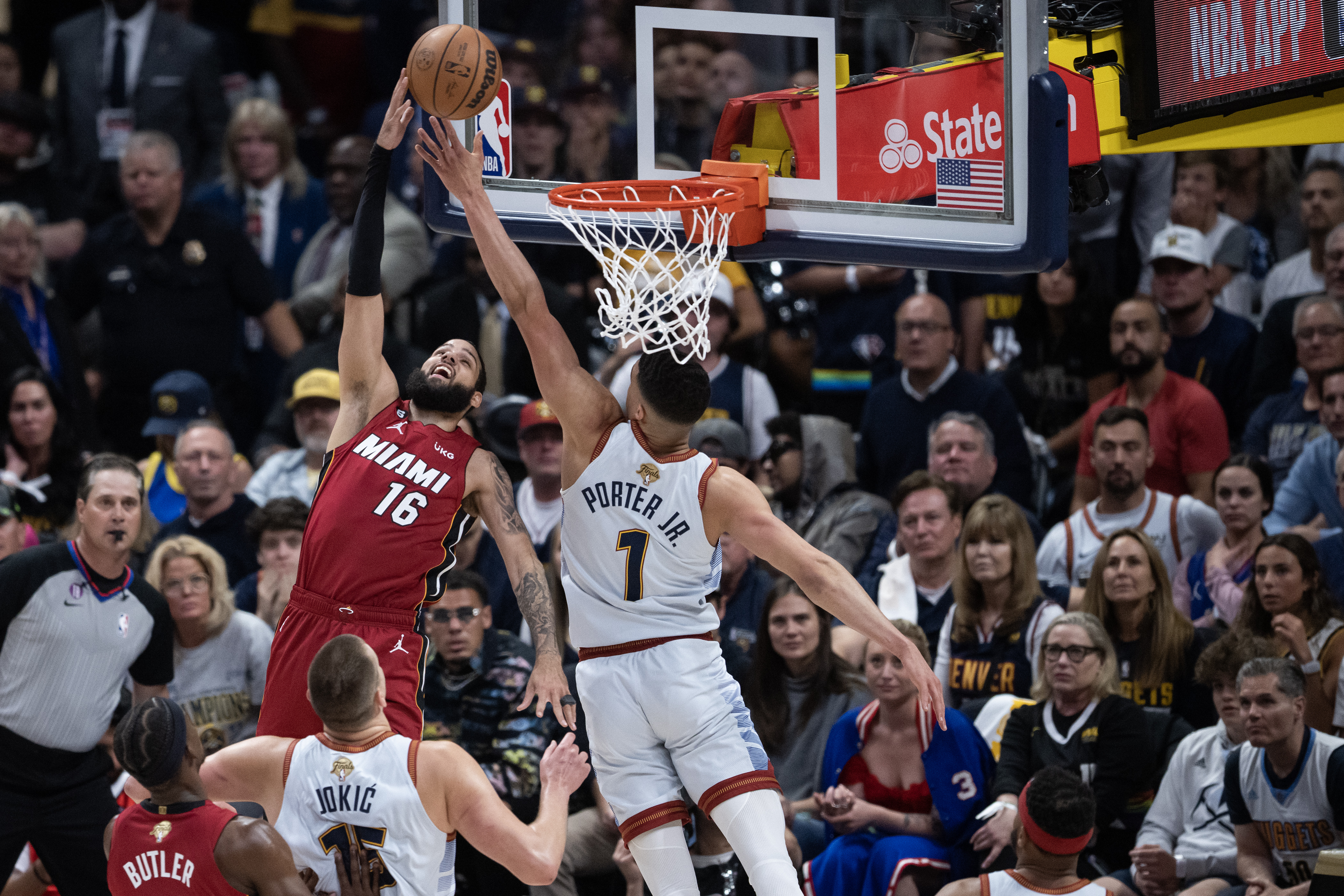 Miami Heat forward Caleb Martin (16) gets a layup past defending Denver Nuggets forward Michael Porter Jr. (1) during the first quarter of Game 5 of the NBA Finals on Monday, June 12, 2023, at Ball Arena in Denver. (Timothy Hurst/Denver Gazette) (TimHursttim.hurst@gazette.comhttps://secure.gravatar.com/avatar/aca82bd62b4ee425c598527cd6faa1b1?d=mm&r=g)