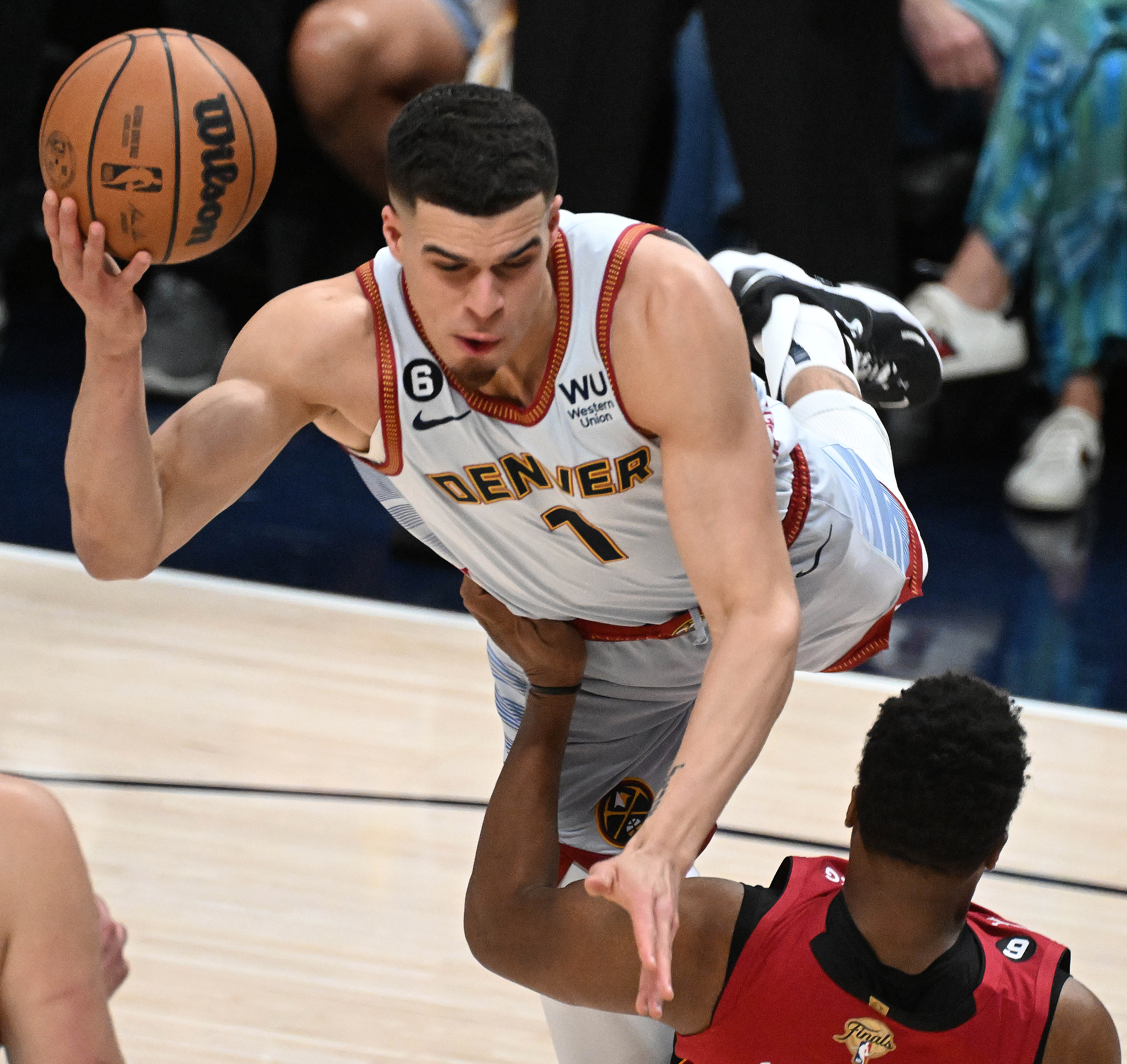 Denver Nuggets forward Michael Porter Jr. (1) goes Superman over Miami Heat guard Kyle Lowry (7) during the first quarter of game 5 of the NBA Finals at Ball Arena on Monday, June 12, 2023. (Photo by Jerilee Bennett, The Gazette)