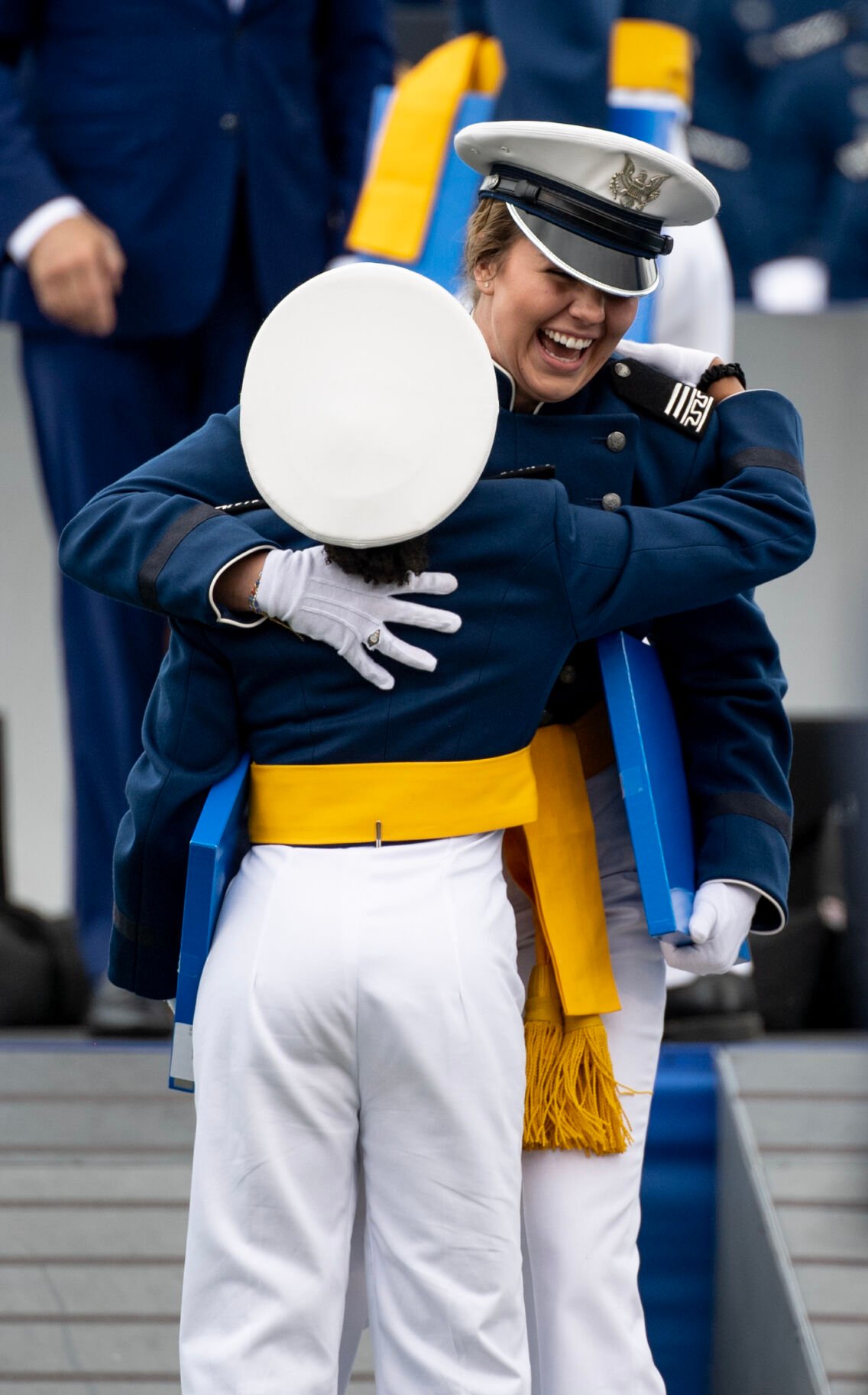 Cadets embrace after receiving their diplomas during the Air Force Academy graduation ceremony at Falcon Stadium on Thursday, June 1, 2023. (Parker Seibold, The Gazette) (Parker Seibold)
