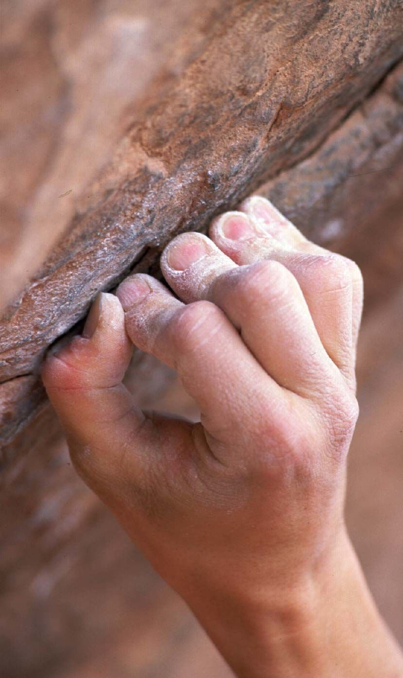 Kevin Branford hangs on to a crack while climbing in the Garden of the Gods Tuesday, April 22. Reis photo