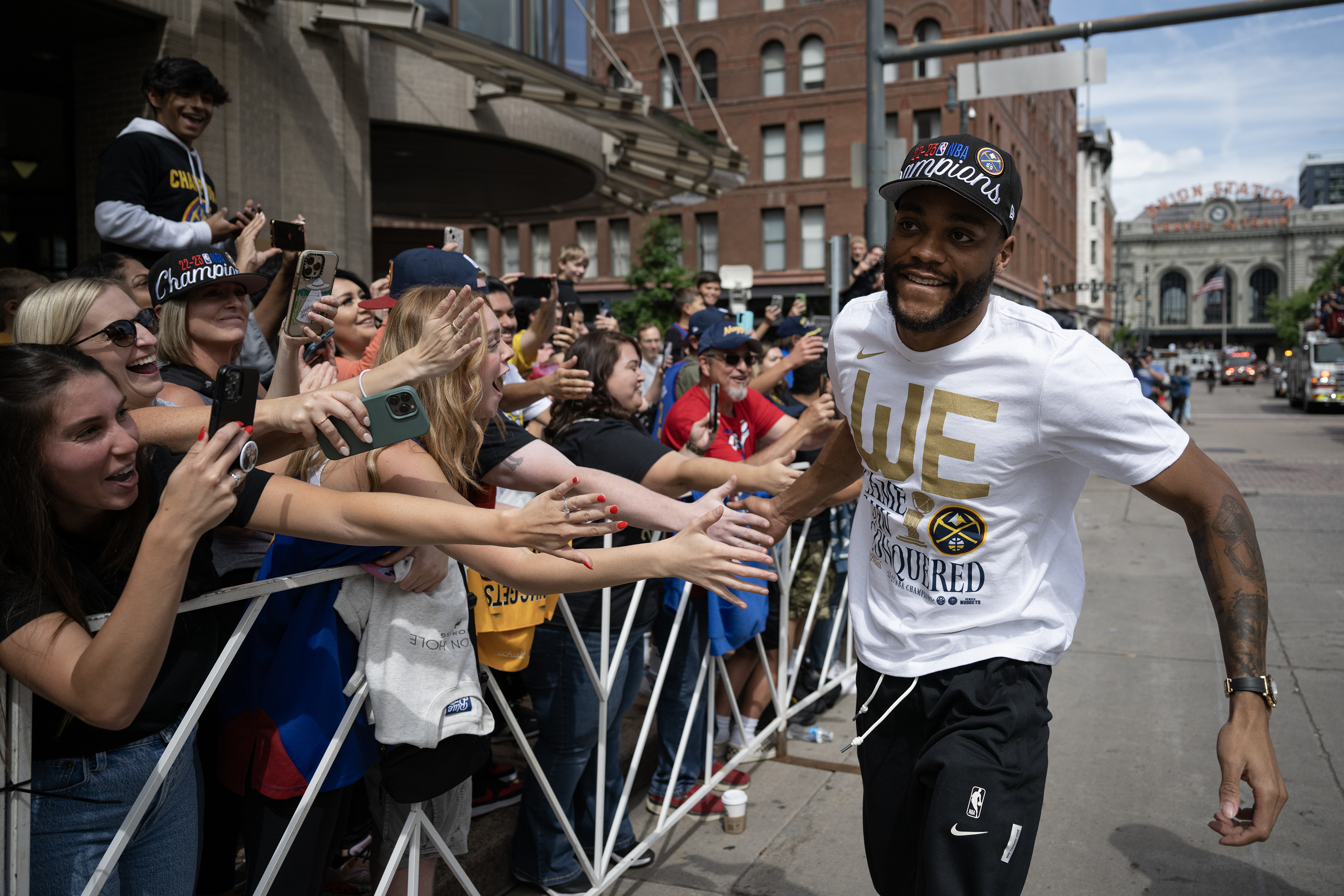Denver Nuggets’ Bruce Brown high-fives crowd members during the Champions Parade and Rally on June 15 in Denver. (TimHursttim.hurst@gazette.comhttps://secure.gravatar.com/avatar/aca82bd62b4ee425c598527cd6faa1b1?d=mm&r=g)
