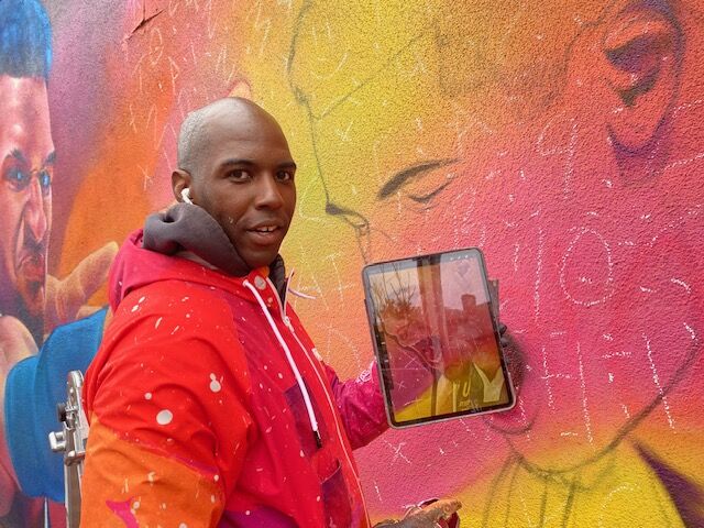 Muralist Detour, aka Thomas Evans, poses for a picture next to his Denver Nuggets mural on Colfax Avenue and Race Street Monday. Detour paints from an IPad and uses numbers lightly drawn into the wall to help him with scale. (CarolMcKinleyDenver Enterprise Reportercarol.mckinley@gazette.comhttps://denvergazette.com/content/tncms/avatars/5/c3/a0f/5c3a0fbe-1007-11ec-9e18-b7f42cfa4b0f.9565a0ce58866e86bcf18260621c2a46.png)