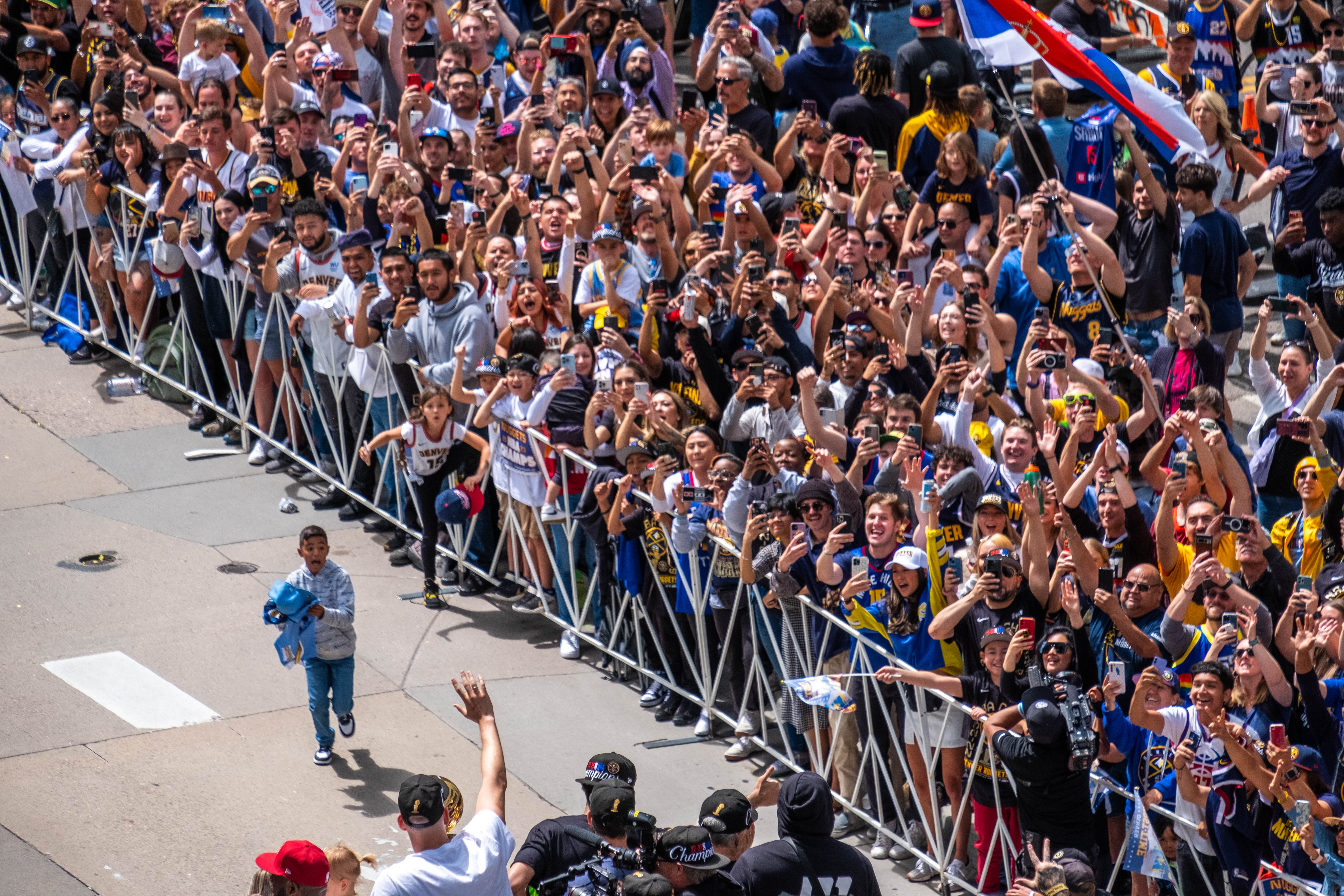 Denver Nuggets Nikola Jokic left, waves to Frans from atop a Denver Fire Department truck during a parade Thursday morning, June 15, 2023 through downtown Denver to celebrate the NBA franchise’s first league championship. (Jonathan Ingraham/The Denver Gazette)