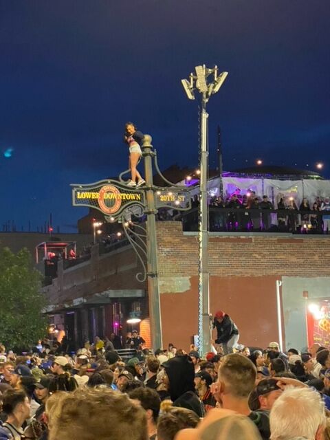 At 20th and Market, Denver Nuggets fans spilled into the street and climbed light poles. Some lit roman candles and some even fell. There were no reports of serious injuries. (Bear Gutierrez/Special to the Denver Gazette)