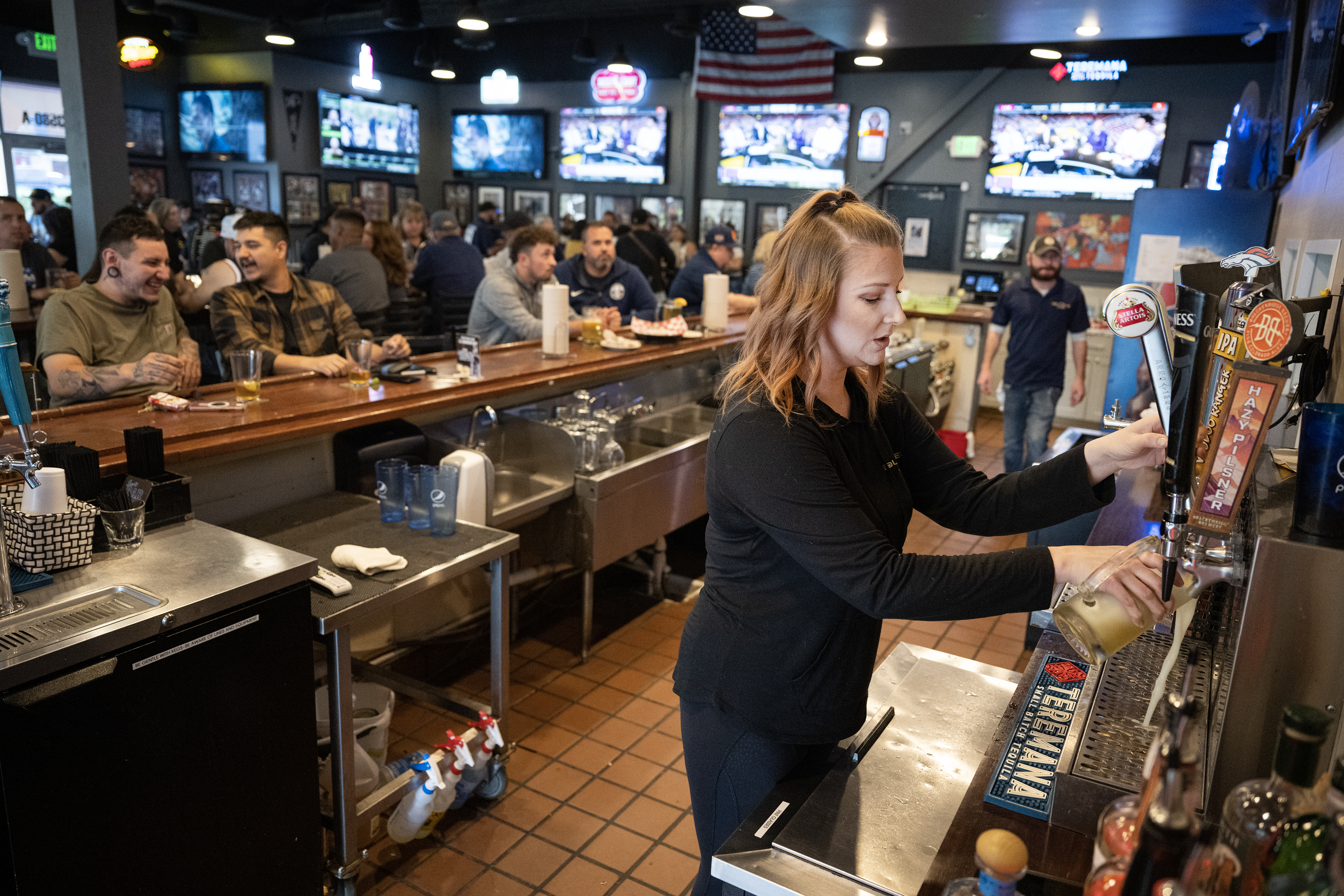 General manager and co-proprietor Nicole Bokelman pours a beer for a customer before the Denver Nuggets fourth NBA Finals game against the Miami Heat, on Friday, June 9, 2023, at ‘Bout Time Pub & Grub in Sheridan, Colo. (Timothy Hurst/Denver Gazette) (TimHursttim.hurst@gazette.comhttps://secure.gravatar.com/avatar/aca82bd62b4ee425c598527cd6faa1b1?d=mm&r=g)