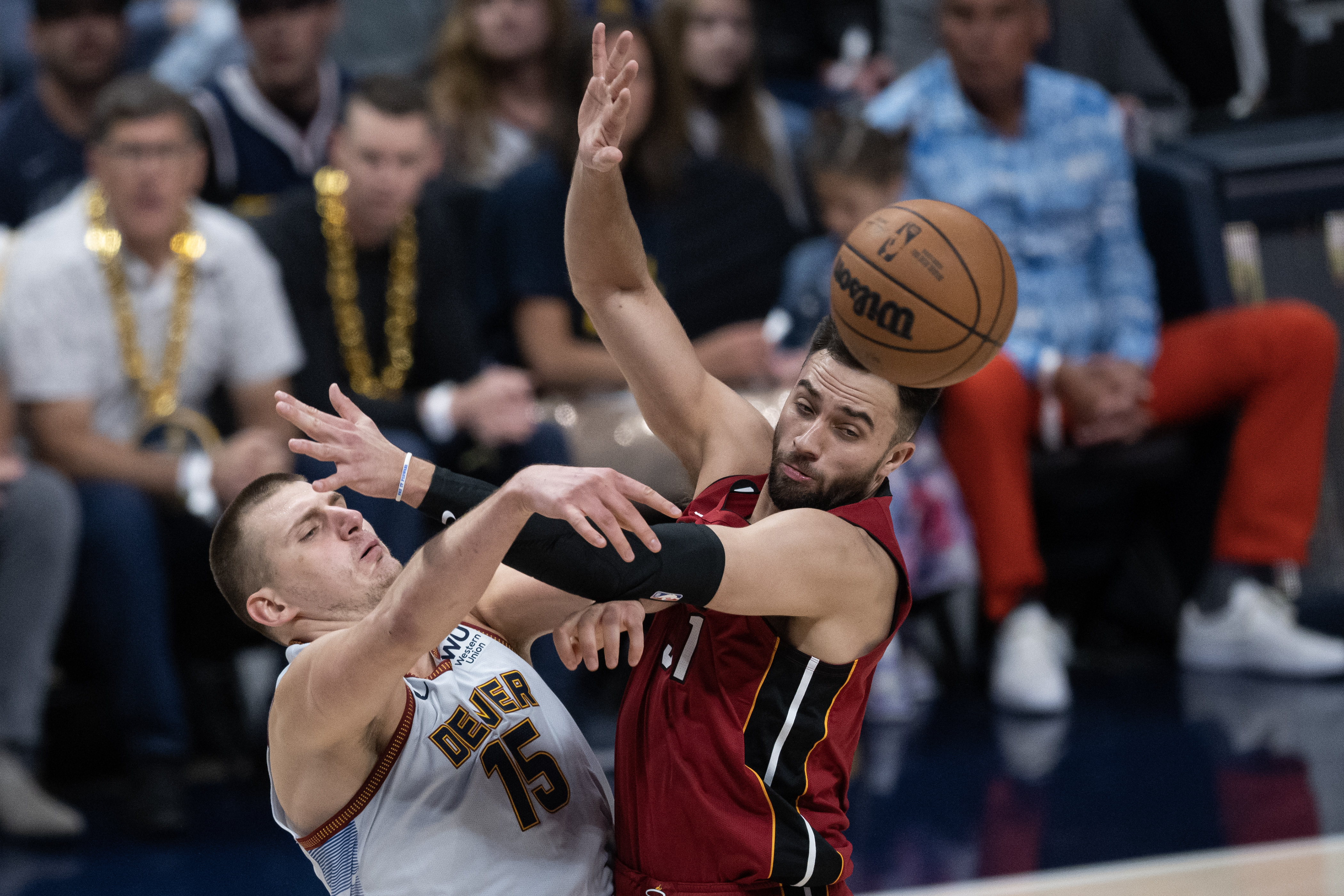 Denver Nuggets center Nikola Jokic (15) gets a pass past Miami Heat guard Max Strus (31) during the first quarter of Game 5 of the NBA Finals on Monday, June 12, 2023, at Ball Arena in Denver. (Timothy Hurst/Denver Gazette) (TimHursttim.hurst@gazette.comhttps://secure.gravatar.com/avatar/aca82bd62b4ee425c598527cd6faa1b1?d=mm&r=g)