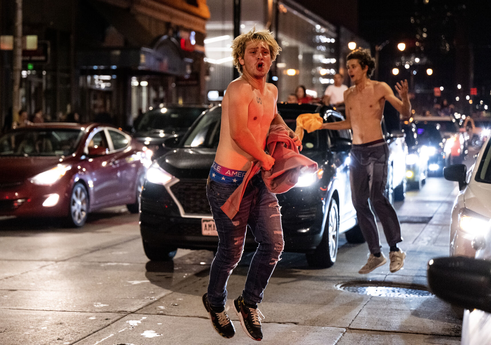 Enthusiastic Denver Nuggets fans run through the streets shirtless after the NBA championship game on Monday, June 12, 2023. (Parker Seibold, The Gazette) (Parker Seibold)