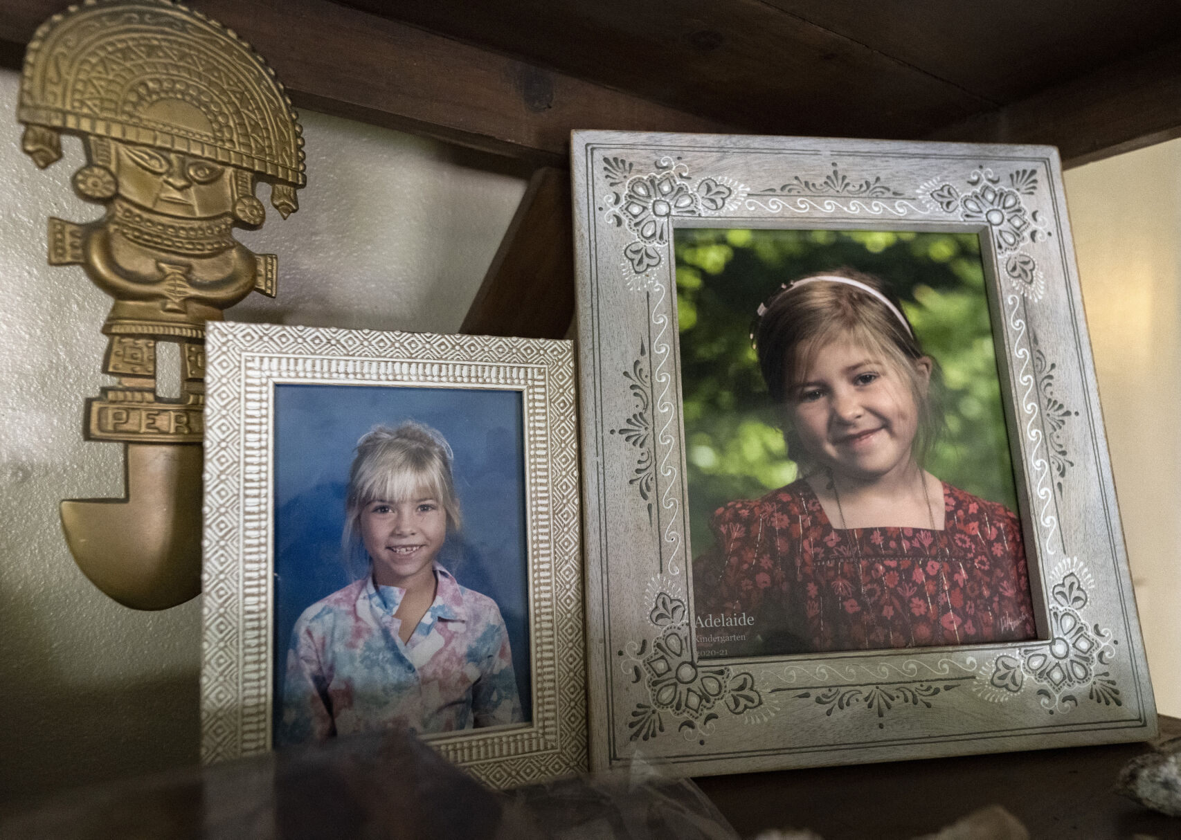 Pictures of Dreama Walton, at age 7, left, and her daughter, Adelaide in kindergarten are displayed Wednesday, June 7, 2023, on a bookshelf in their Colorado Springs home. (The Gazette, Christian Murdock) (Christian Murdock/The Gazette)