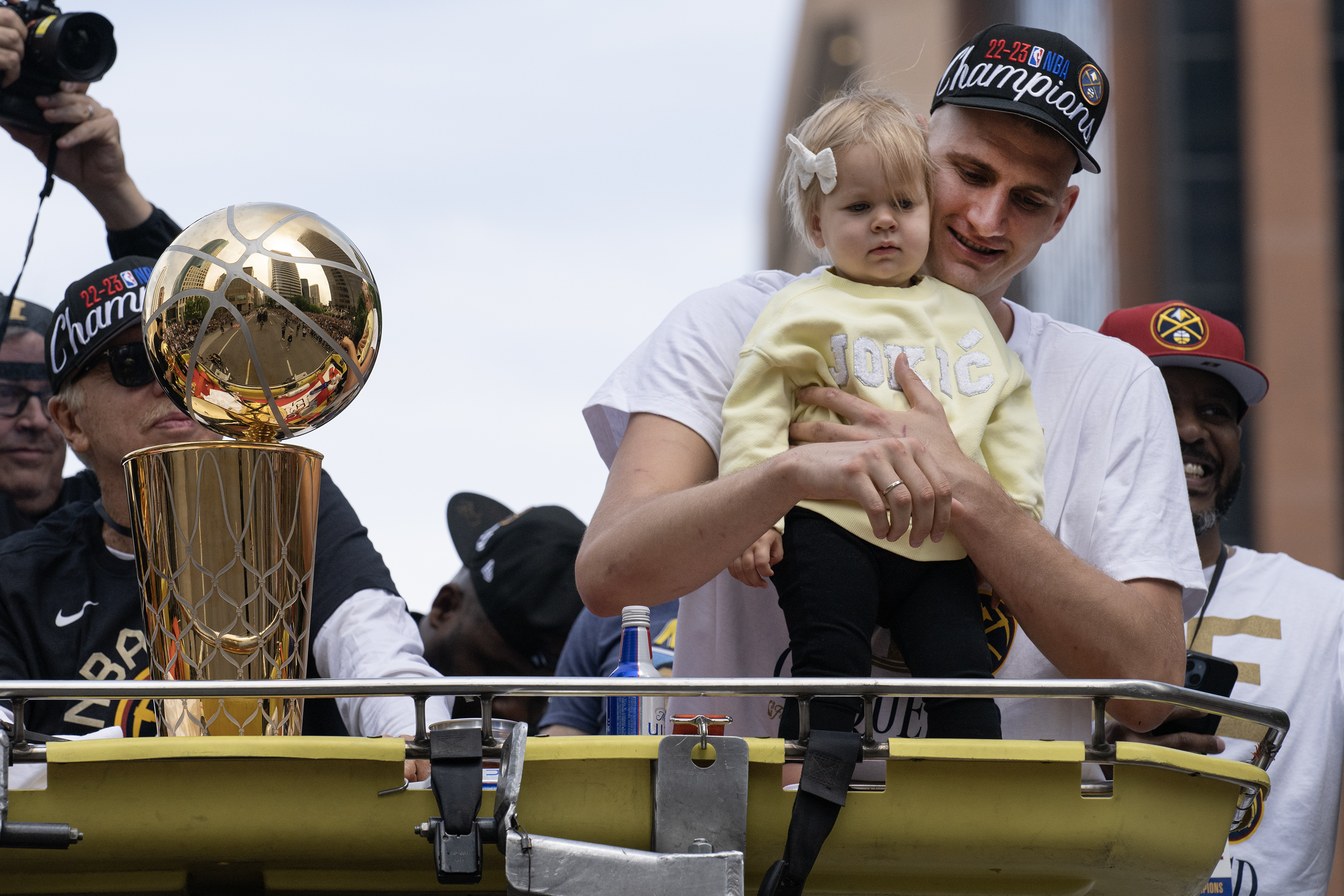 Denver Nuggets center Nikola Jokic holds his daughter Ognjena next to the Larry O’Brien Championship Trophy during the Denver Nuggets 2023 Champions Parade and Rally on Thursday, June 14, 2023, in Denver. (Timothy Hurst/Denver Gazette)
