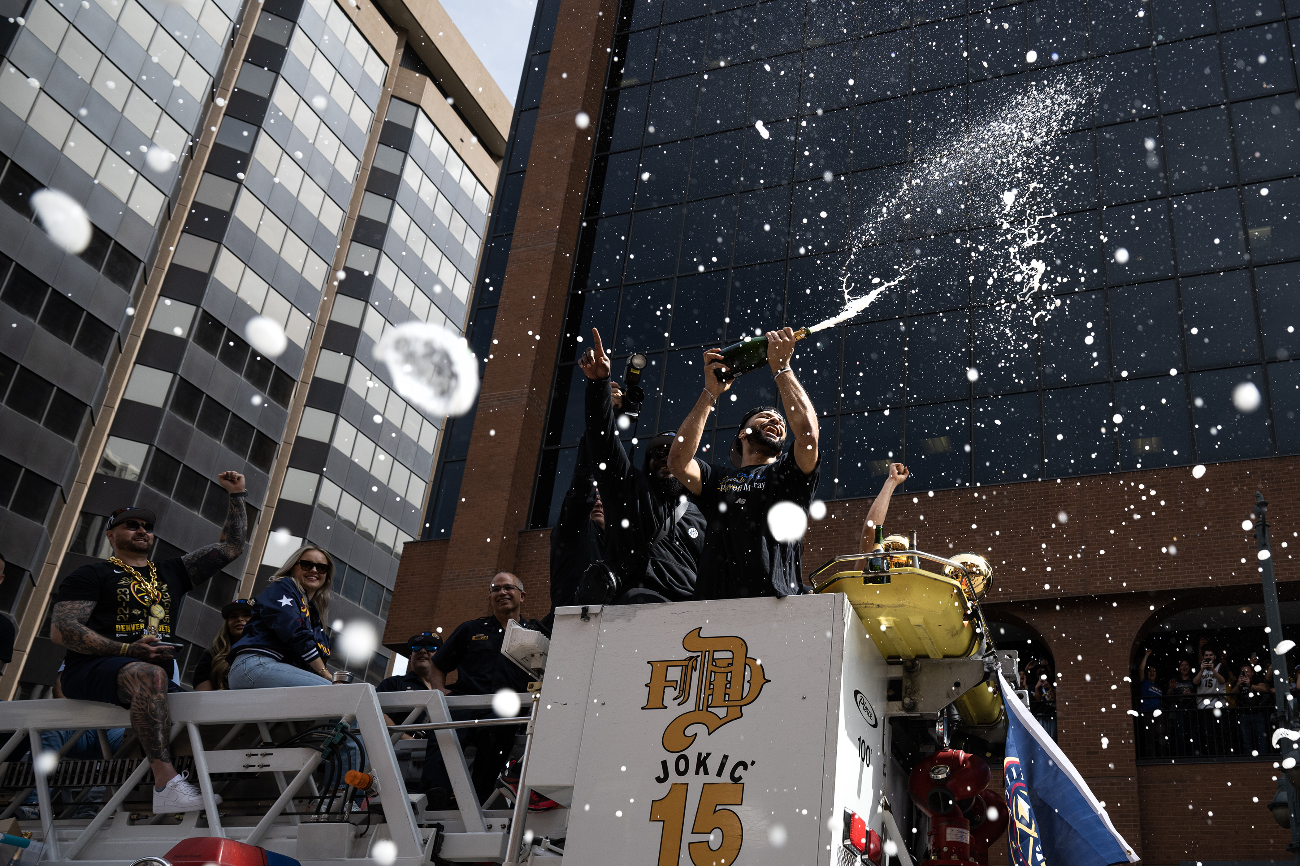 Denver Nuggets point guard Jamal Murray sprays champagne during the Denver Nuggets 2023 Champions Parade and Rally on Thursday, June 15, 2023, in Denver. (TimHursttim.hurst@gazette.comhttps://secure.gravatar.com/avatar/aca82bd62b4ee425c598527cd6faa1b1?d=mm&r=g)