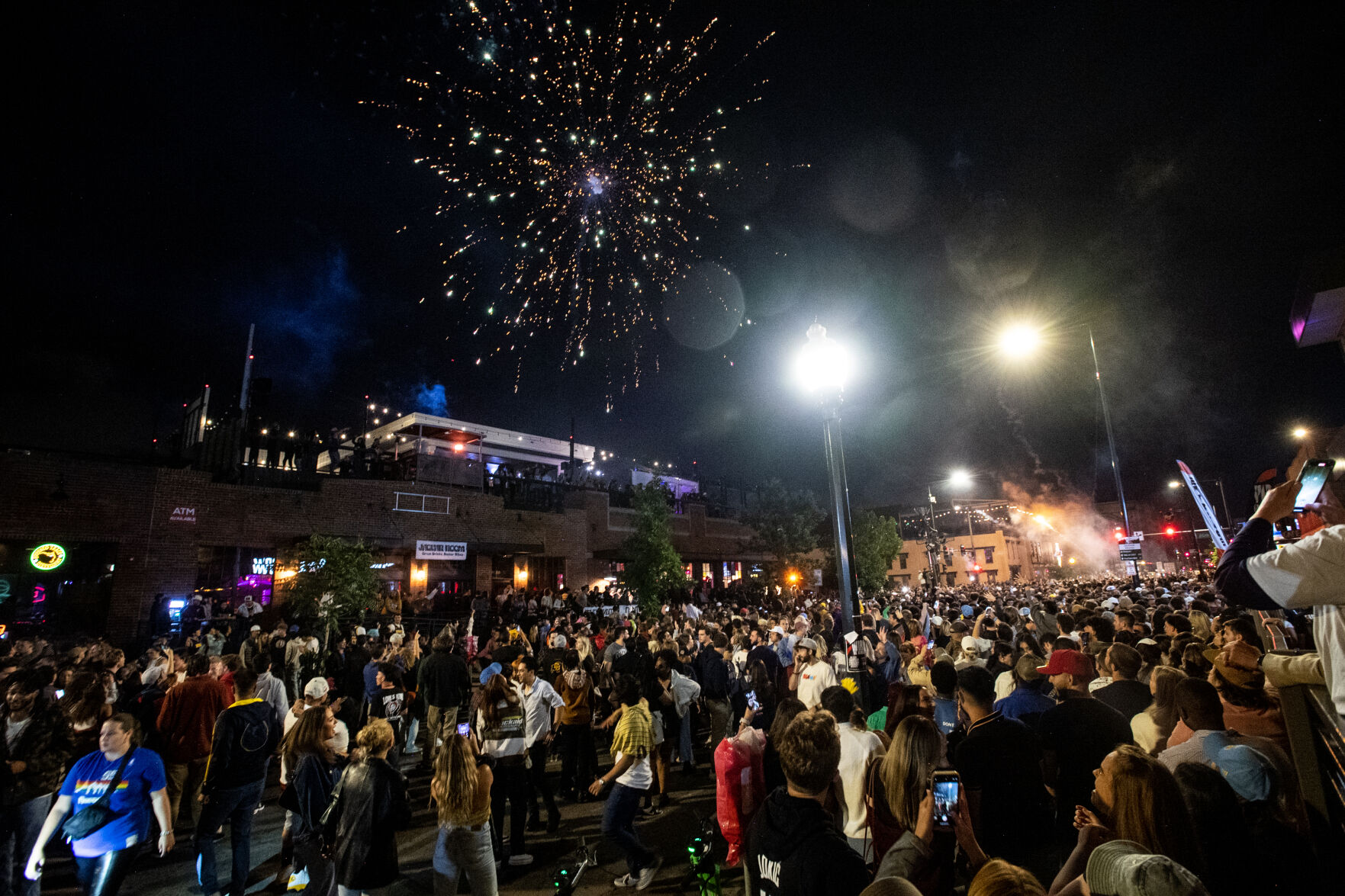 Fireworks go off above thousands of people packed onto Market Street in Denver after the Nuggets won the NBA championship game on Monday, June 12, 2023. (Parker Seibold, The Gazette) (Parker Seibold)