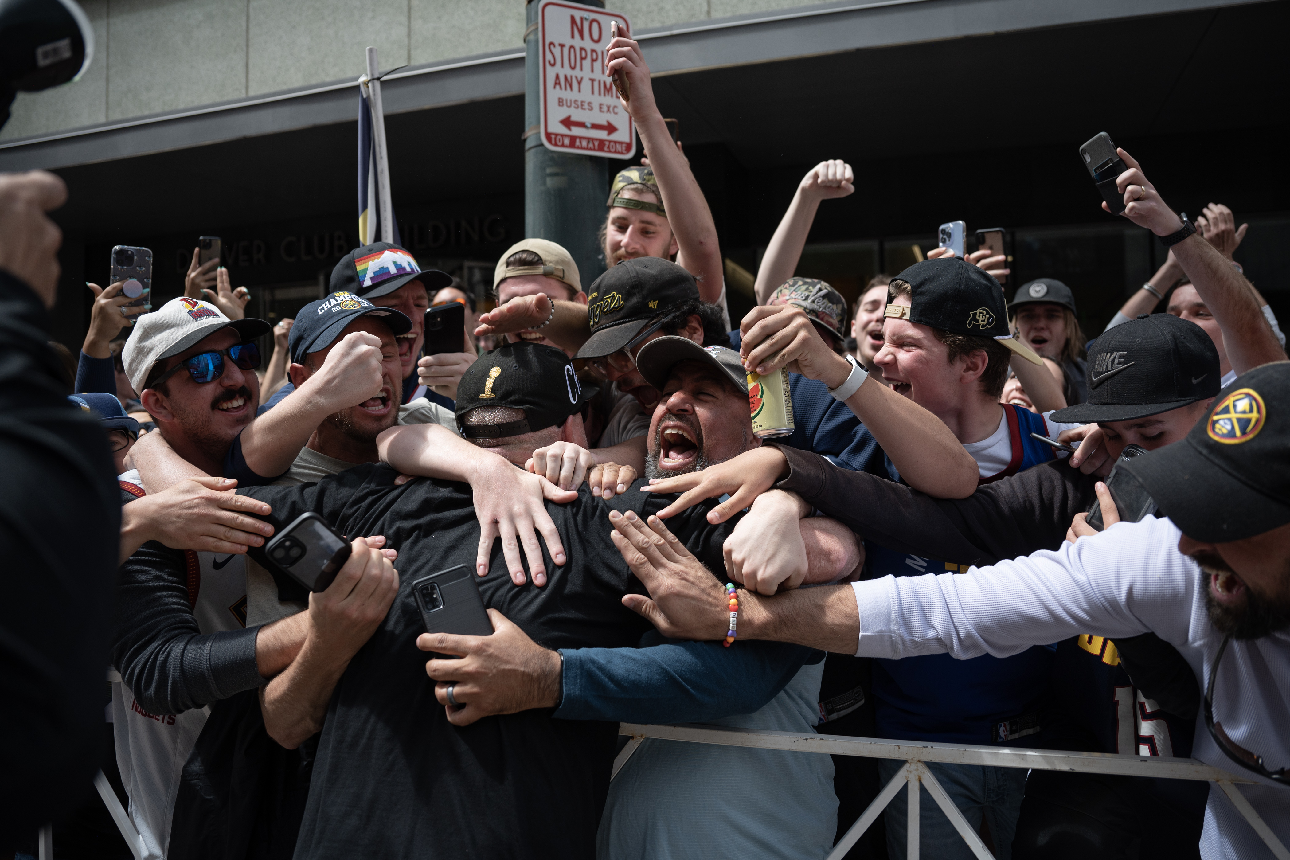 Head Coach Michael Malone leans in a hugs fans during the Denver Nuggets 2023 Champions Parade and Rally on Thursday, June 15, 2023, in Denver. (Timothy Hurst/Denver Gazette) (TimHursttim.hurst@gazette.comhttps://secure.gravatar.com/avatar/aca82bd62b4ee425c598527cd6faa1b1?d=mm&r=g)