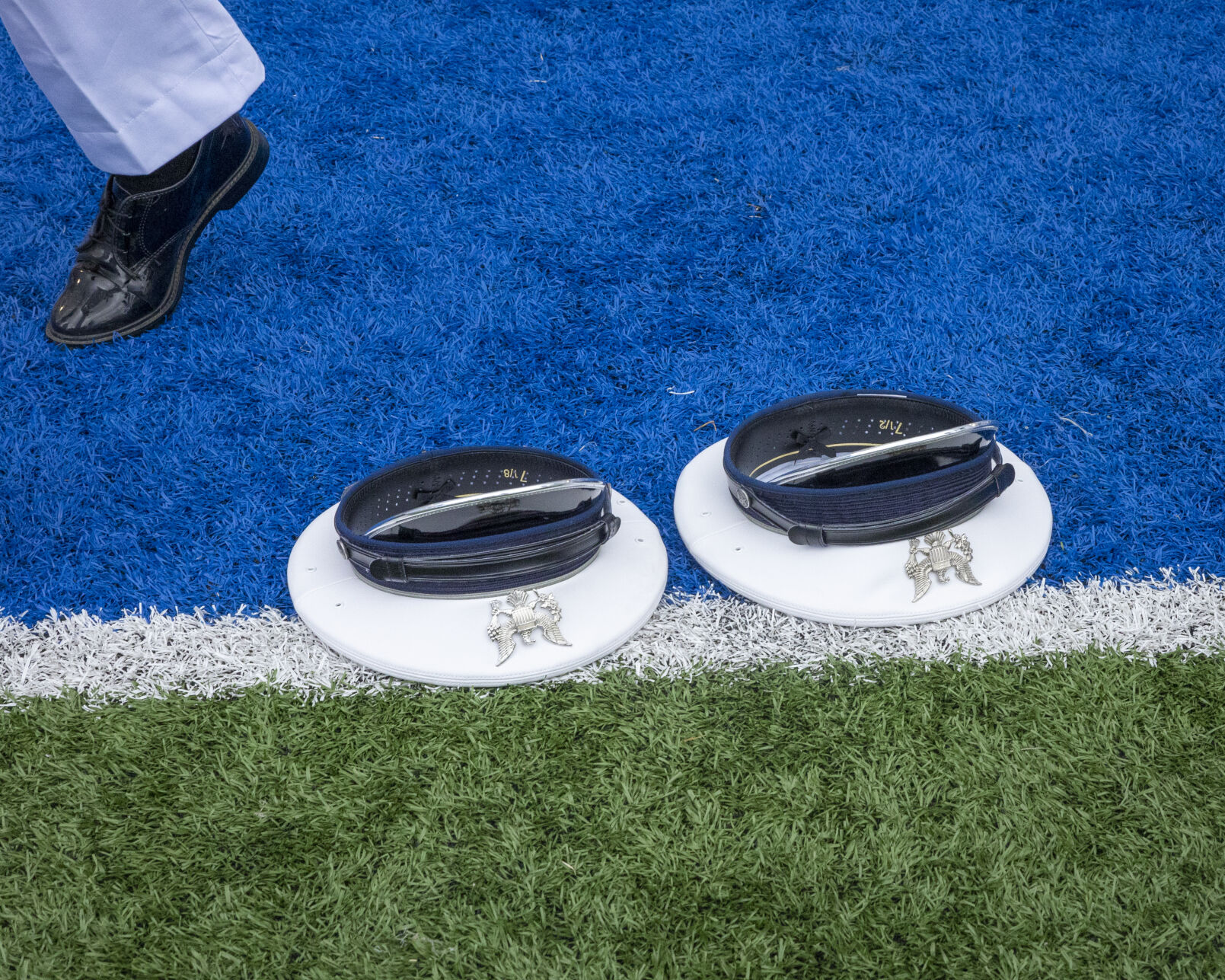 Two graduated cadets’ hats are left behind after the hat toss for the children to find at the end of the U.S. Air Force Academy Class of 2023 Graduation at Falcon Stadium on the U.S. Air Force Academy campus in Colorado Springs, Co., on Thursday, June 1, 2023. (GabiBroekemaPhoto Interngabi.broekema@gazette.comhttps://secure.gravatar.com/avatar/9aa2a13da1acfaa50410cb37bf21fdb1?d=mm&r=g)