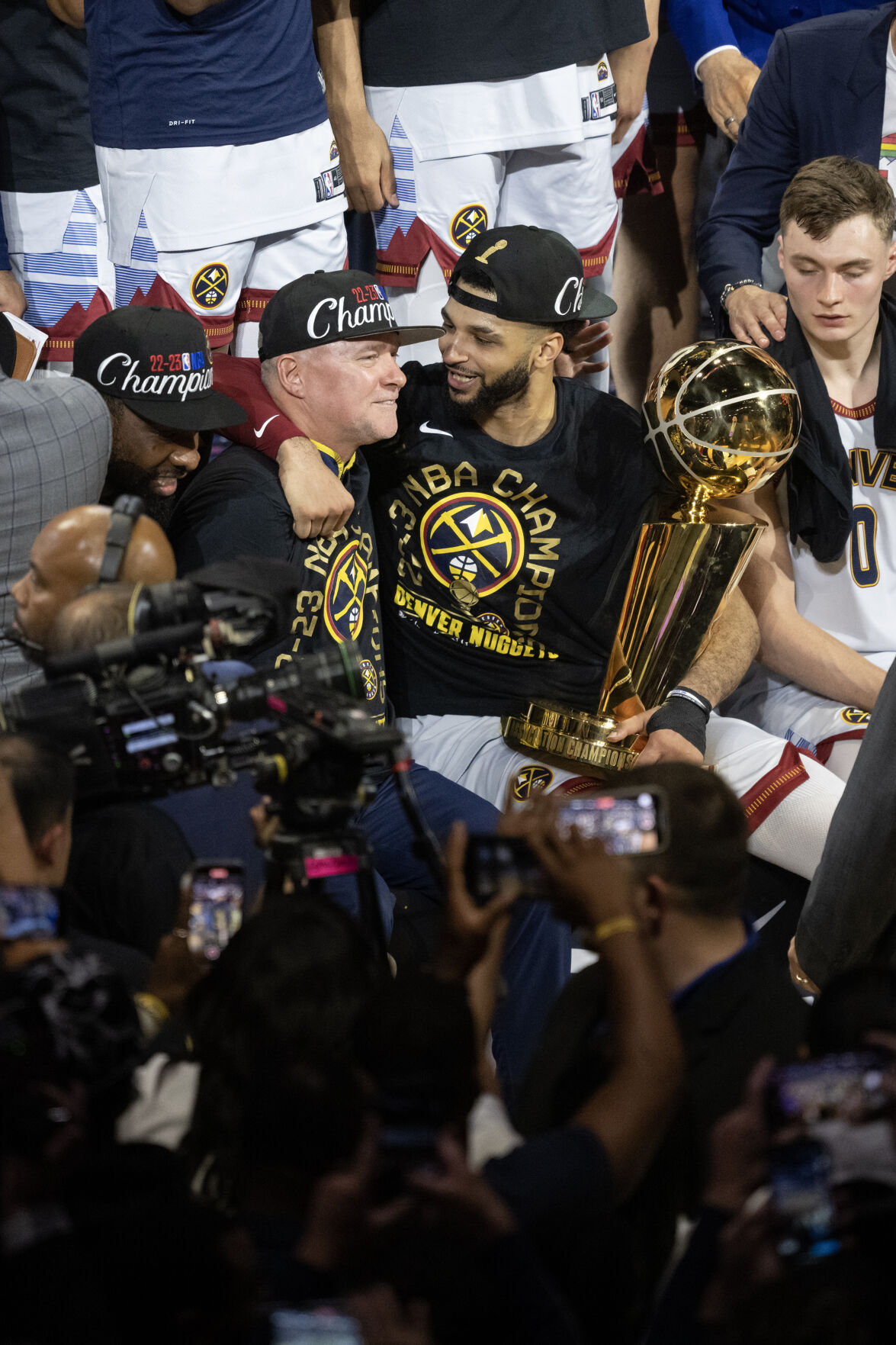 Denver Nuggets guard Jamal Murray (27) and head coach Michael Malone reacts as Murray holds the Larry O’Brien Championship Trophy after a 94-89 win over the Miami Heat in Game 5 of the NBA Finals on Monday at Ball Arena in Denver.061323-s-dg-Game5-Finals26.JPG (Timothy Hurst, THE Gazette)