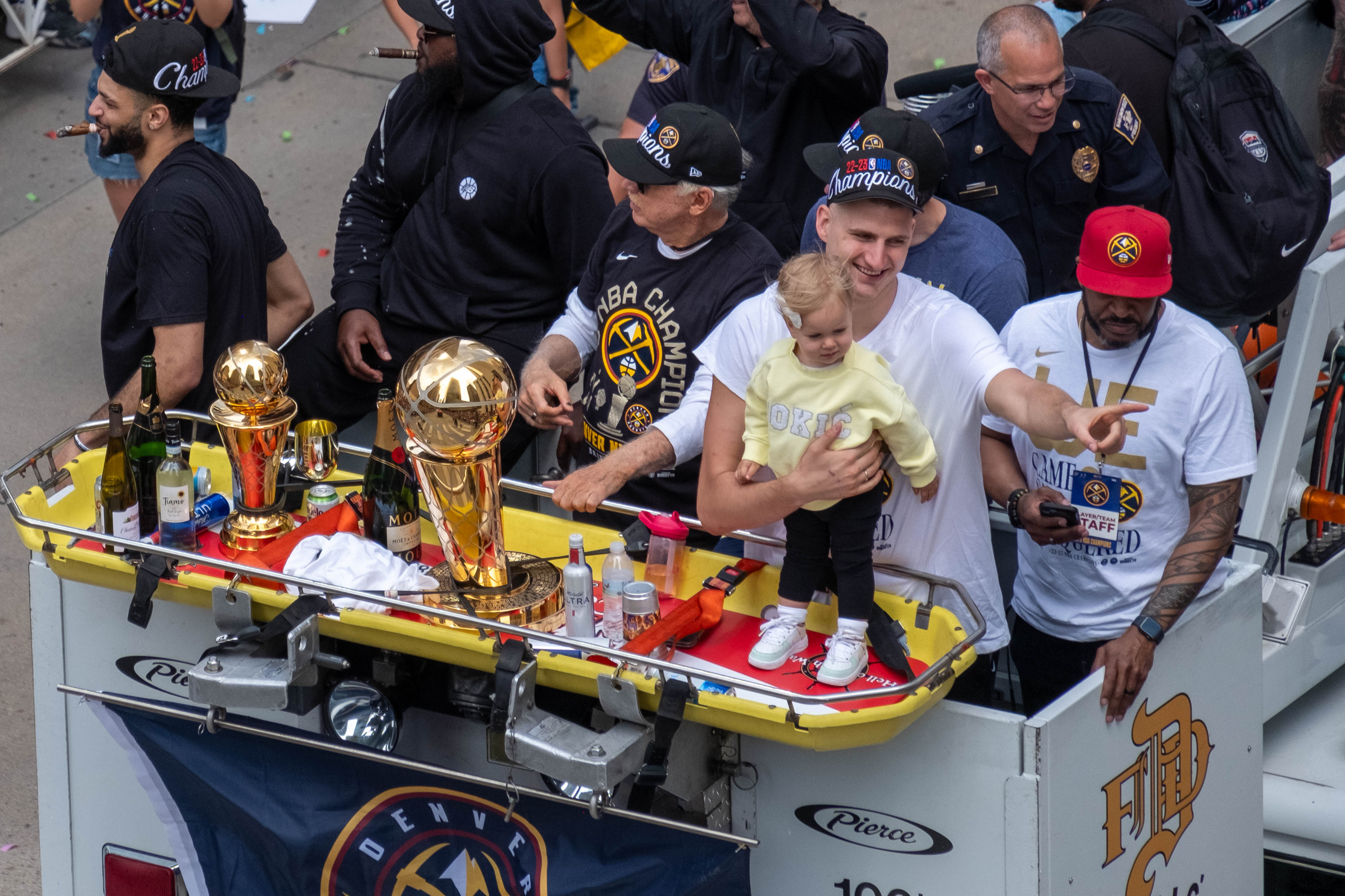 Denver Nuggets Nikola Jokic, second from right, holds his daughter, Ognjena, atop a Denver Fire Department truck during a parade Thursday morning, June 15, 2023 through downtown Denver to celebrate the NBA franchise’s first league championship. (Jonathan Ingraham/The Denver Gazette)
