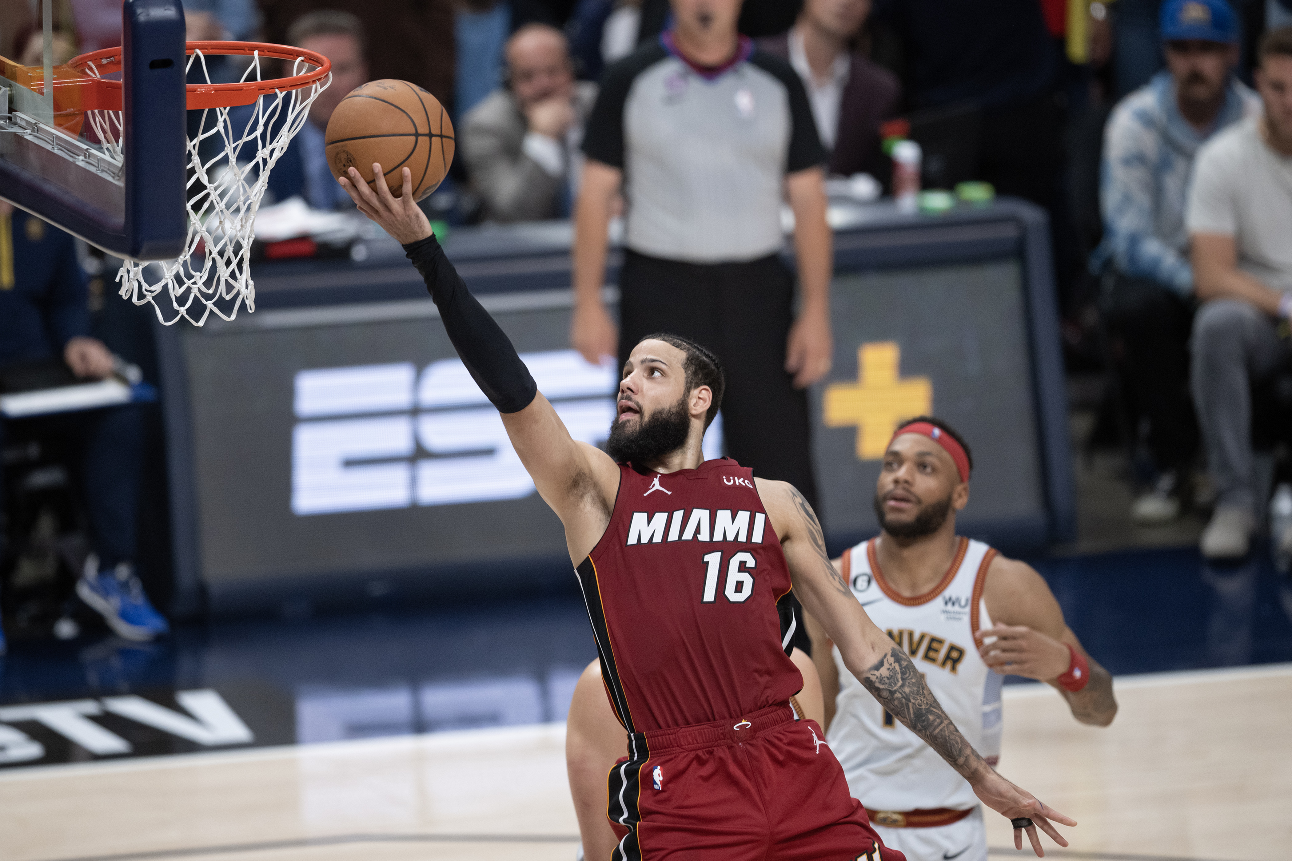 Miami Heat forward Caleb Martin (16) lays it up over Denver Nuggets defenders in a 94-89 loss in Game 5 of the NBA Finals on Monday, June 12, 2023, at Ball Arena in Denver. (Timothy Hurst/Denver Gazette) (TimHursttim.hurst@gazette.comhttps://secure.gravatar.com/avatar/aca82bd62b4ee425c598527cd6faa1b1?d=mm&r=g)