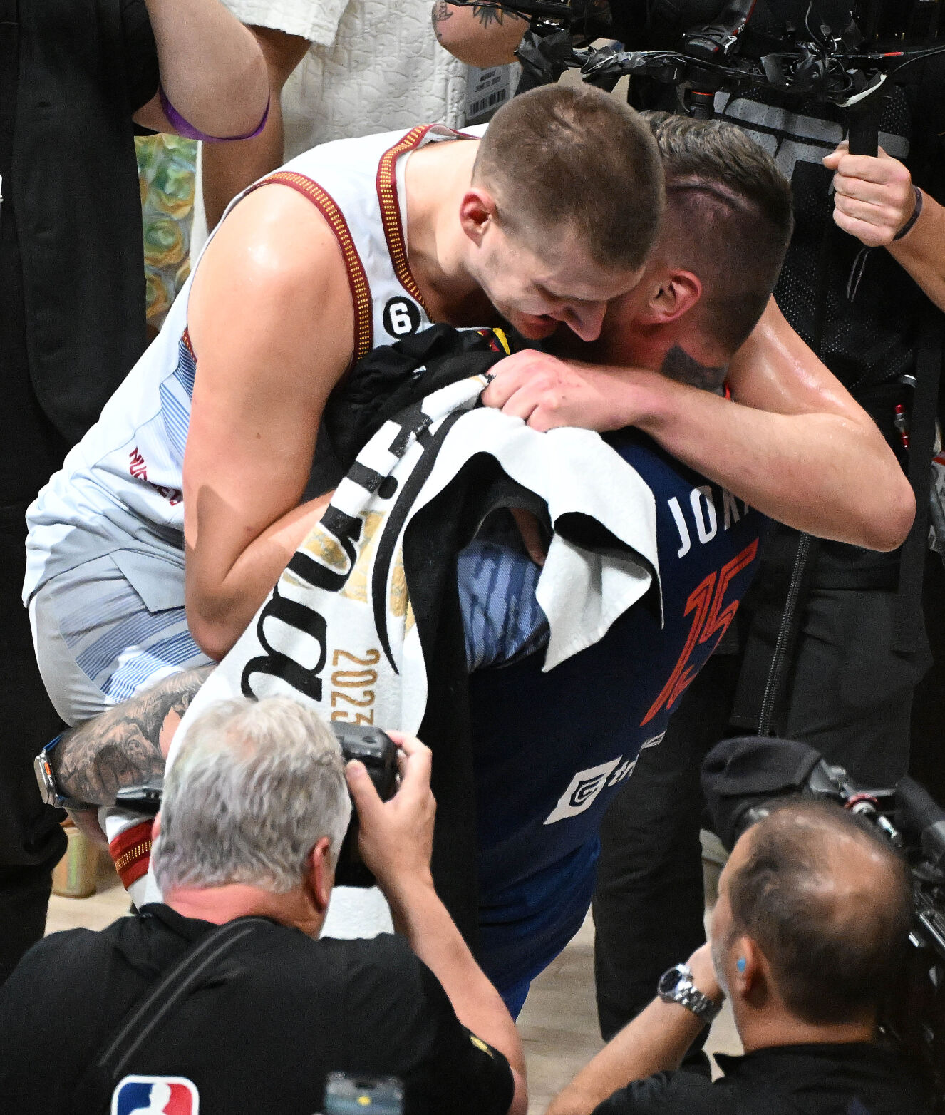 Denver Nuggets center Nikola Jokic (15) is picked up and hugged by his brother, Strahinja Jokic, at Ball Arena on Monday, June 12, 2023. (Photo by Jerilee Bennett, The Gazette)