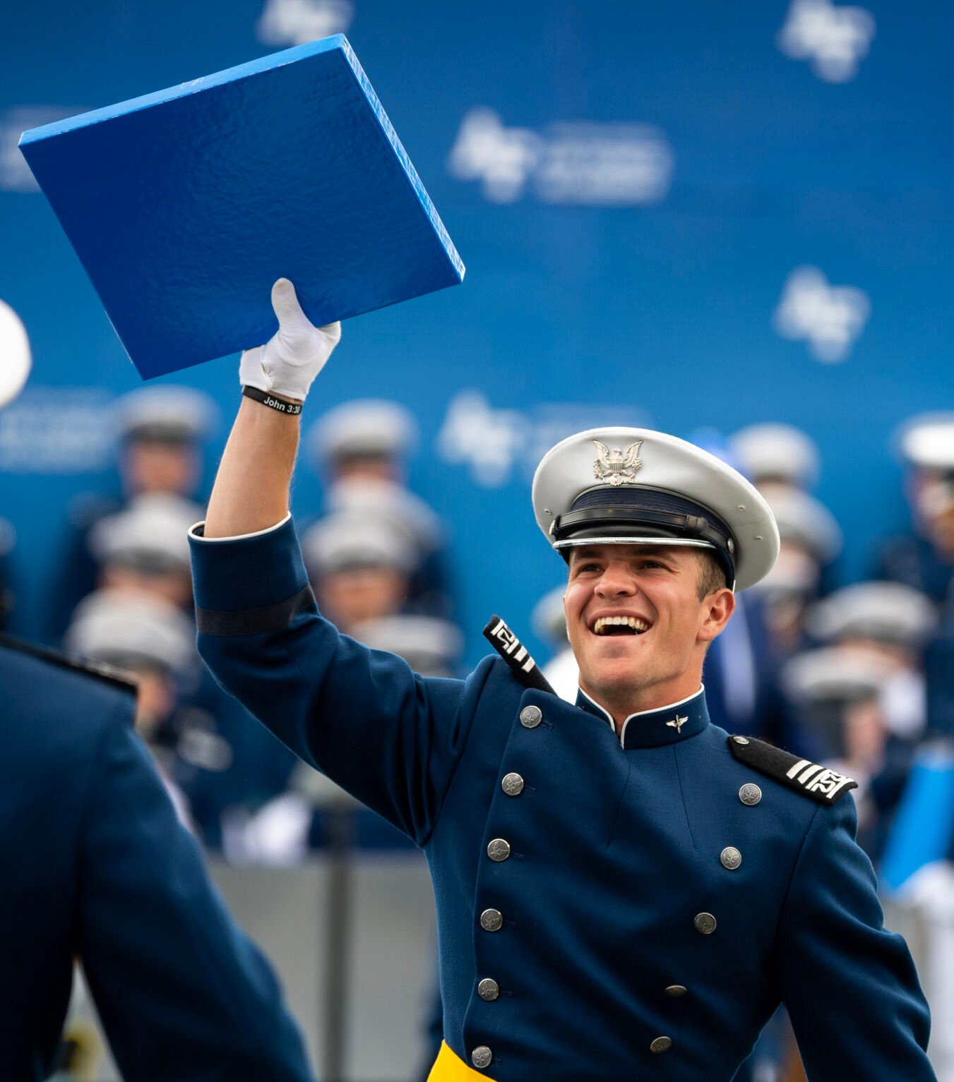 A cadet holds his diploma up for the crowd to see at the Air Force Academy graduation ceremony at Falcon Stadium on Thursday, June 1, 2023. (Parker Seibold, The Gazette) (Parker Seibold)
