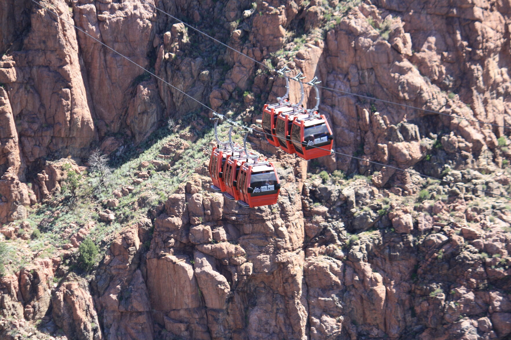 Two aerial gondolas pass each other above Royal Gorge on June 7, 2023. (O'Dell Isaac, The Gazette)