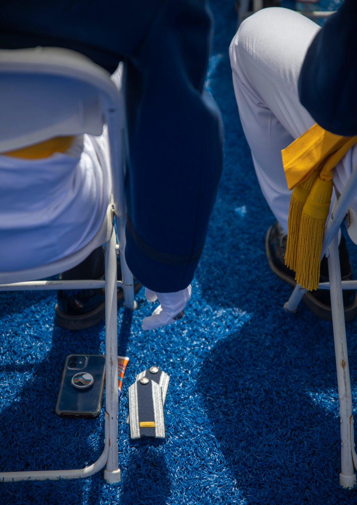 Graduating cadets stashed phones, sun screen and water beside their stripes under their chairs at the U.S. Air Force Academy Class of 2023 Graduation at Falcon Stadium on the U.S. Air Force Academy campus in Colorado Springs, Co., on Thursday, June 1, 2023. (GabiBroekemaPhoto Interngabi.broekema@gazette.comhttps://secure.gravatar.com/avatar/9aa2a13da1acfaa50410cb37bf21fdb1?d=mm&r=g)