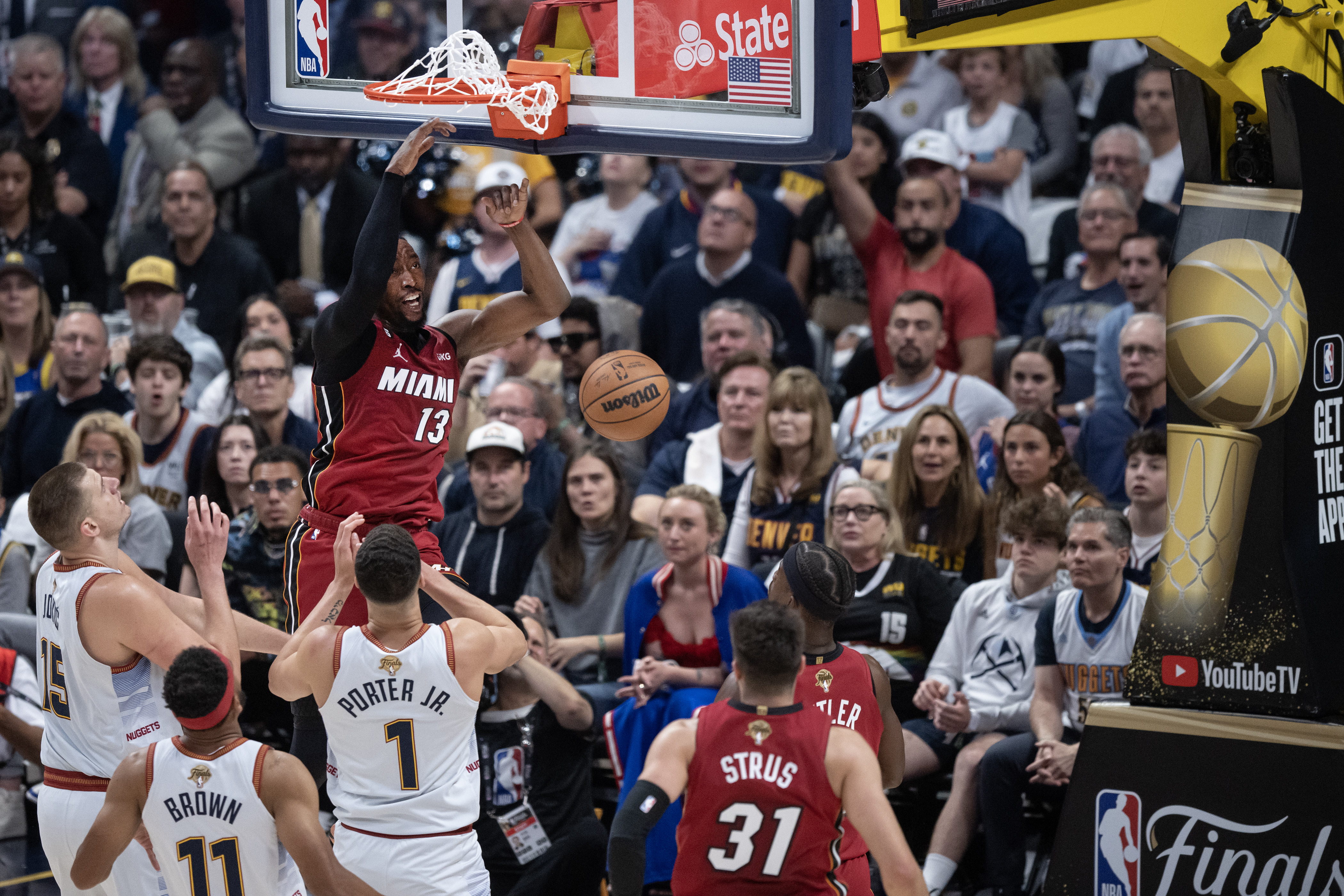 Miami Heat center Bam Adebayo (13) dunks over Denver Nugget defenders during the first quarter of Game 5 of the NBA Finals on Monday, June 12, 2023, at Ball Arena in Denver. (Timothy Hurst/Denver Gazette) (TimHursttim.hurst@gazette.comhttps://secure.gravatar.com/avatar/aca82bd62b4ee425c598527cd6faa1b1?d=mm&r=g)