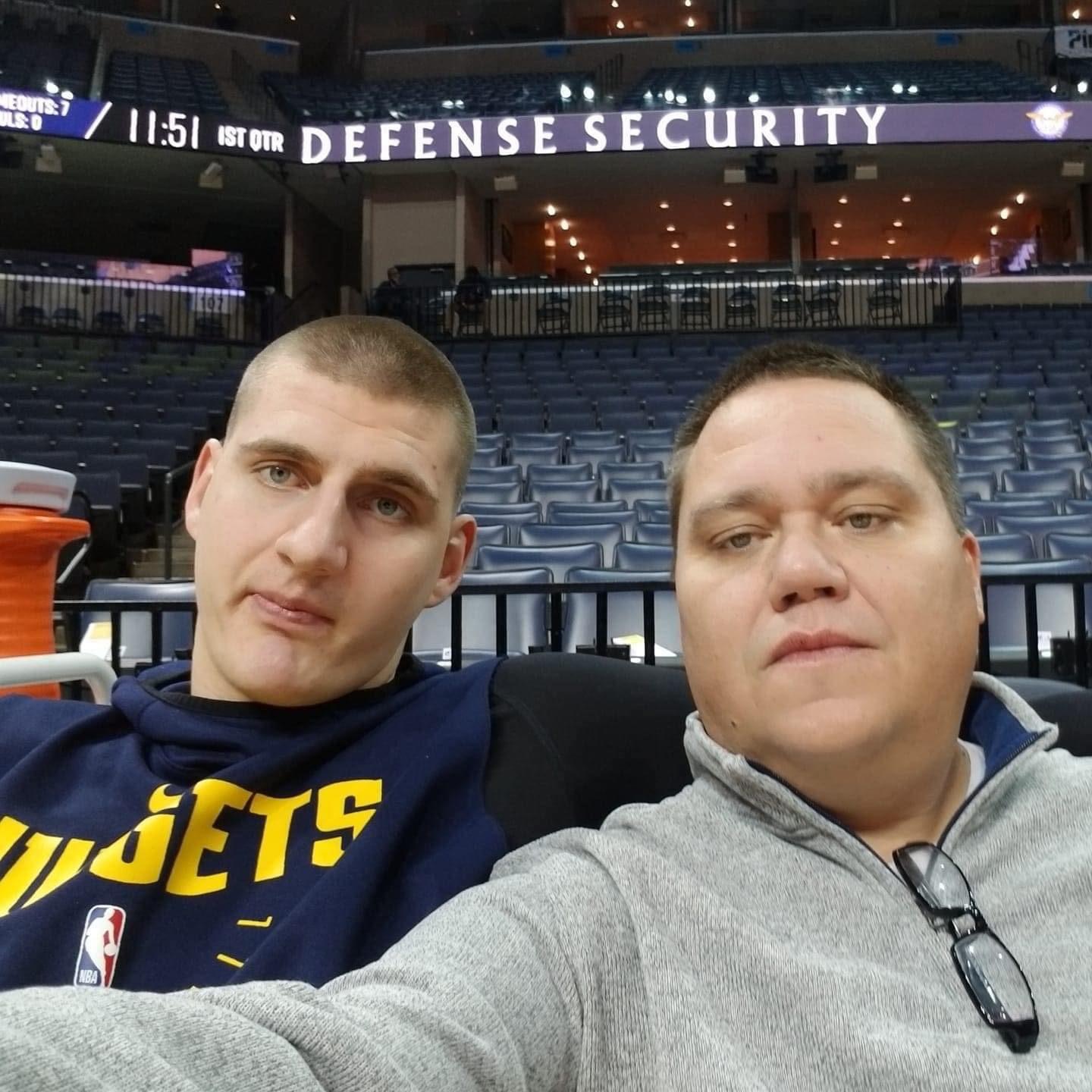 Jason Kosmicki, posing with a fan, is the longtime radio voice of the Nuggets on Altitude Sports. (Courtesy Jason Kosmicki)