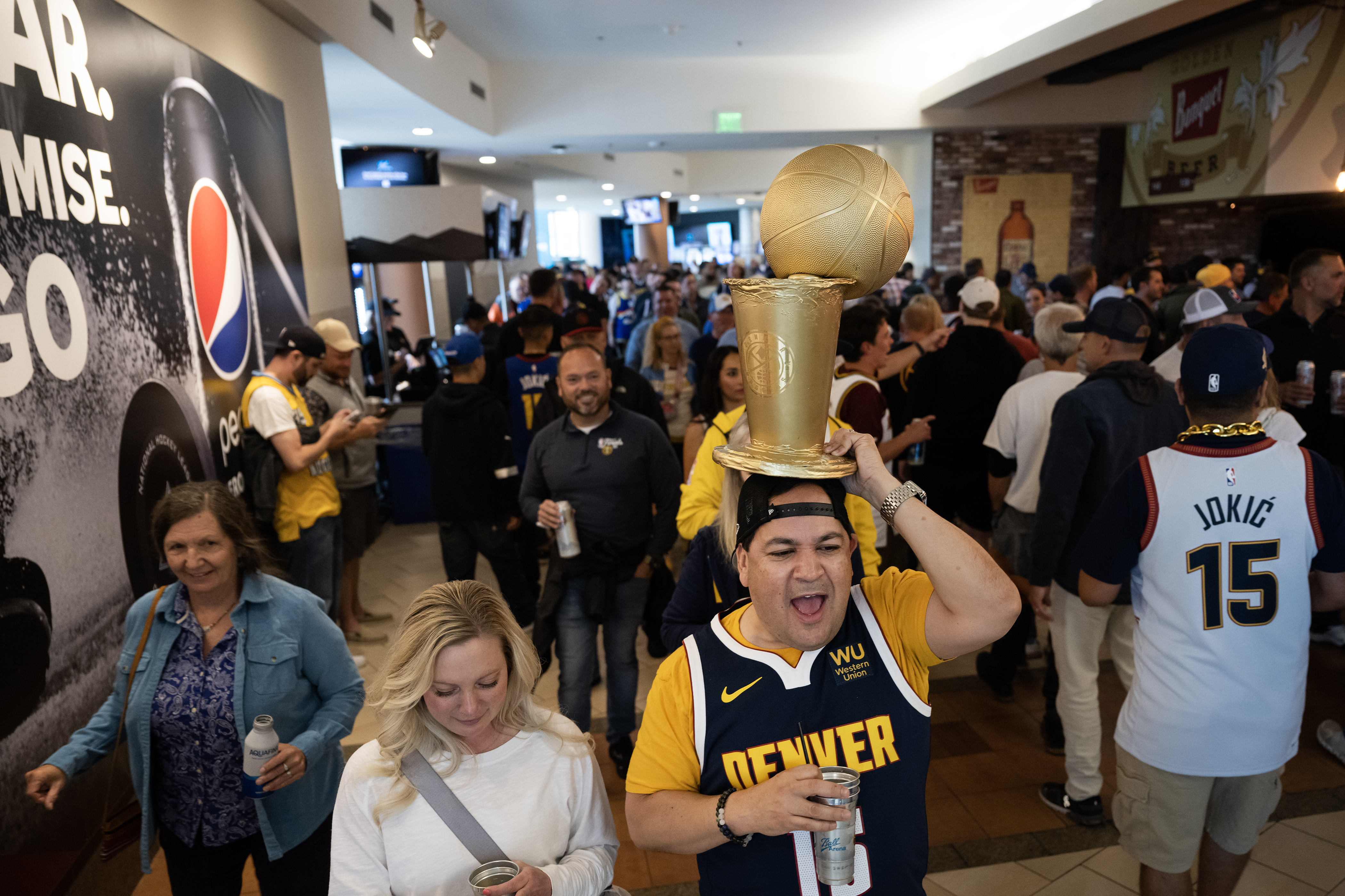 Nuggets fan Martin Mata carries his own Larry O’Brien Championship Trophy before Game 5 of the NBA Finals against the Miami Heat on Monday, June 12, 2023, at Ball Arena in Denver. (Timothy Hurst/Denver Gazette) (TimHursttim.hurst@gazette.comhttps://secure.gravatar.com/avatar/aca82bd62b4ee425c598527cd6faa1b1?d=mm&r=g)