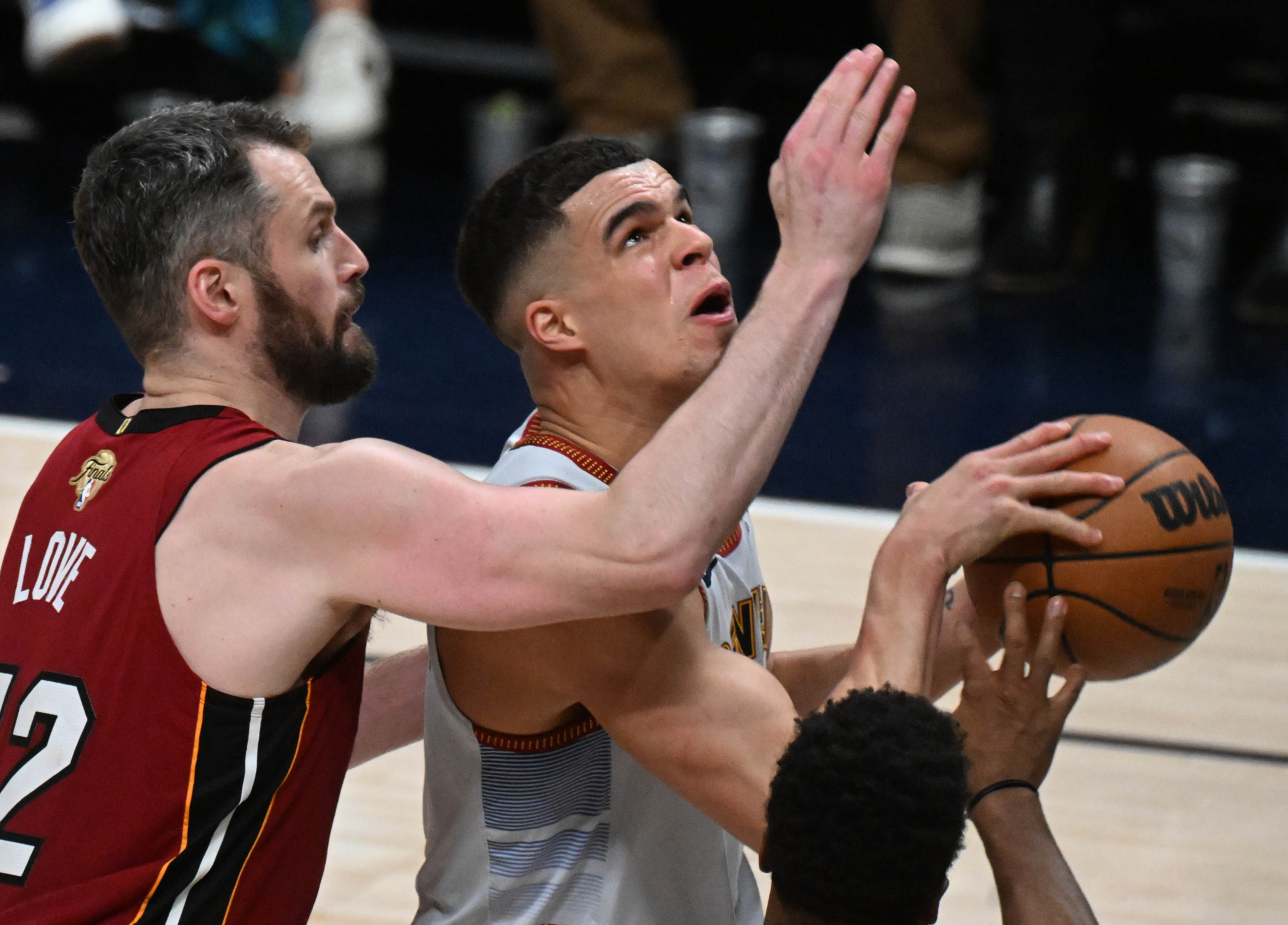 Denver Nuggets forward Michael Porter Jr. (1) is defended by Miami Heat forward Kevin Love (42) during the 2nd quarter of game 5 of the NBA Finals at Ball Arena on Monday, June 12, 2023. (Photo by Jerilee Bennett, The Gazette)