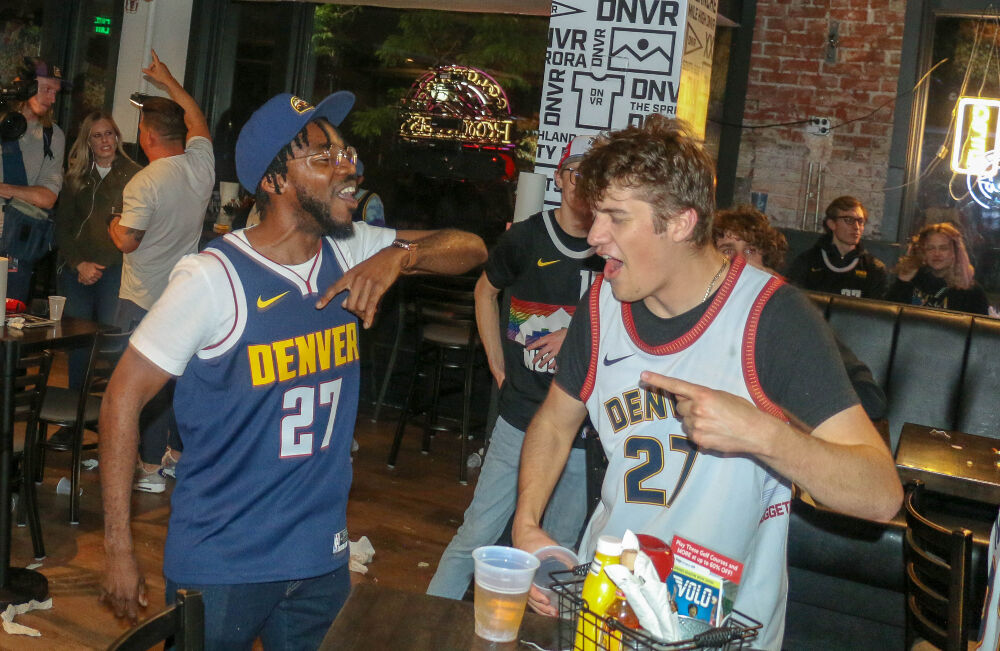 Nuggets fans celebrate at the DNVR bar on Monday night. (John Moore, The Denver Gazette)
