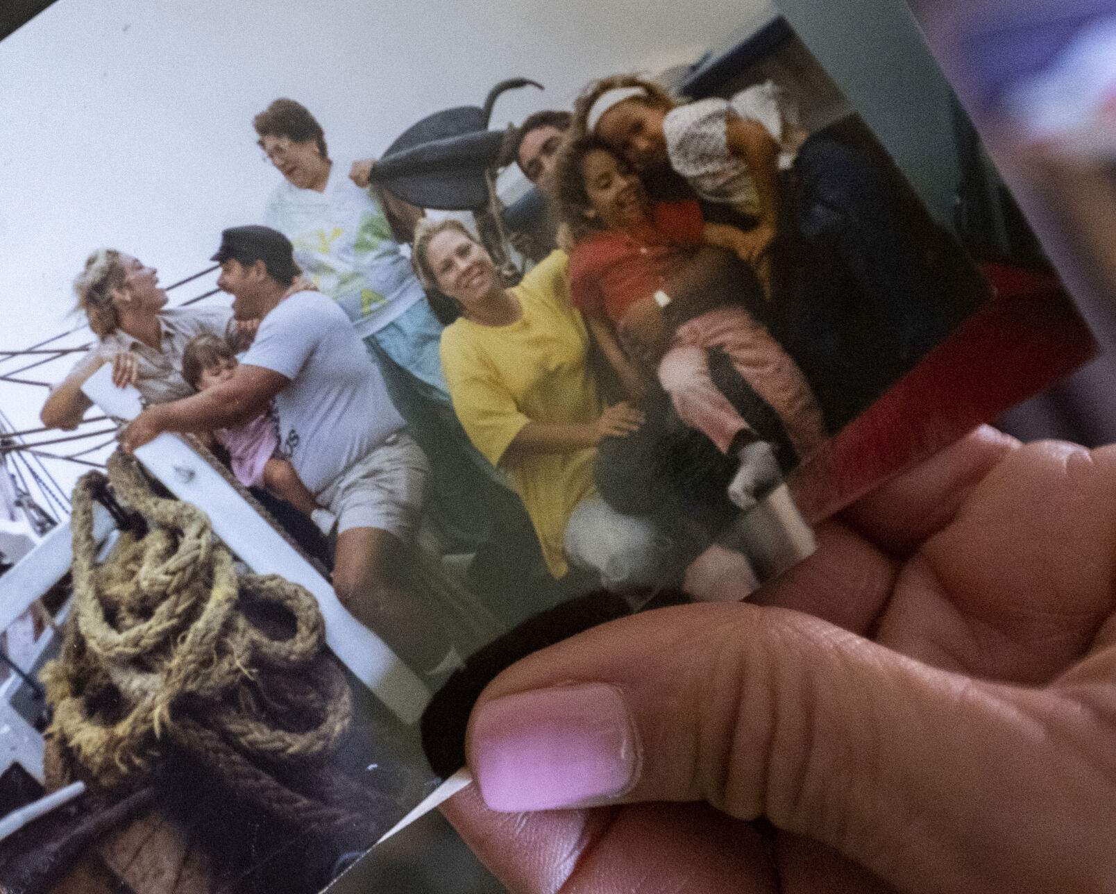 Dreama Walton holds a picture she took of her immediate family on the right, and grandmother, aunt, uncle and cousin on the left during happier times in St. Croix, U.S. Virgin Island in the 1990s. (The Gazette, Christian Murdock) (Christian Murdock/The Gazette)