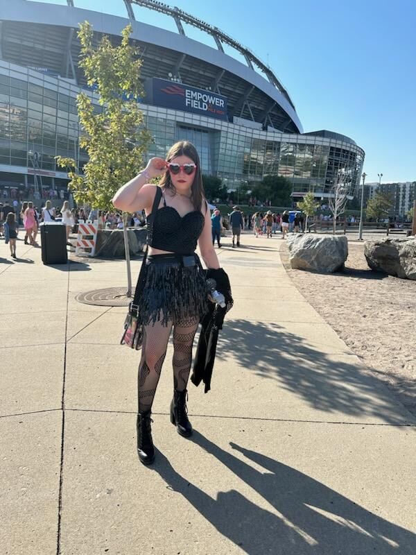 Ms. Huls, 15, of Colorado Springs poses outside Empower Field at Mile High before the Taylor Swift concert Friday in Denver, Colo. She's wearing a