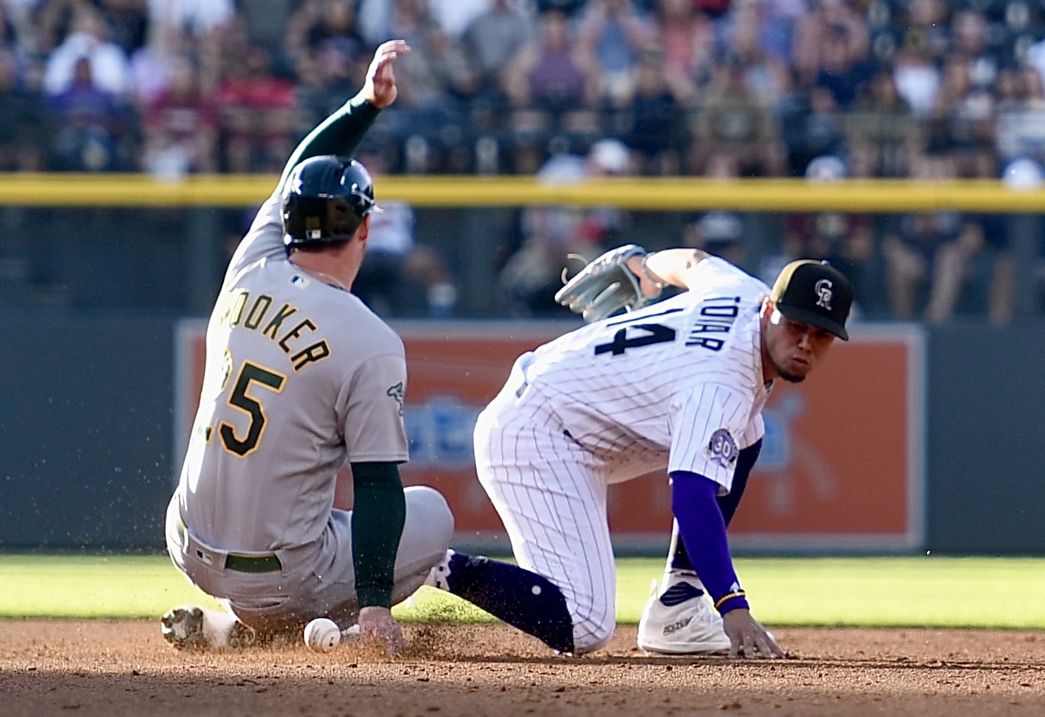 Rockies shortstop Ezequiel Tovar fails to control a ball as Athletics outfielder Brent Rooker base safely on Friday, July 28, 2023. (CarsonFieldcarson.field@gazette.comhttps://secure.gravatar.com/avatar/c524ef3d384945349bed78d70eb2d2cd?d=mm&r=g)