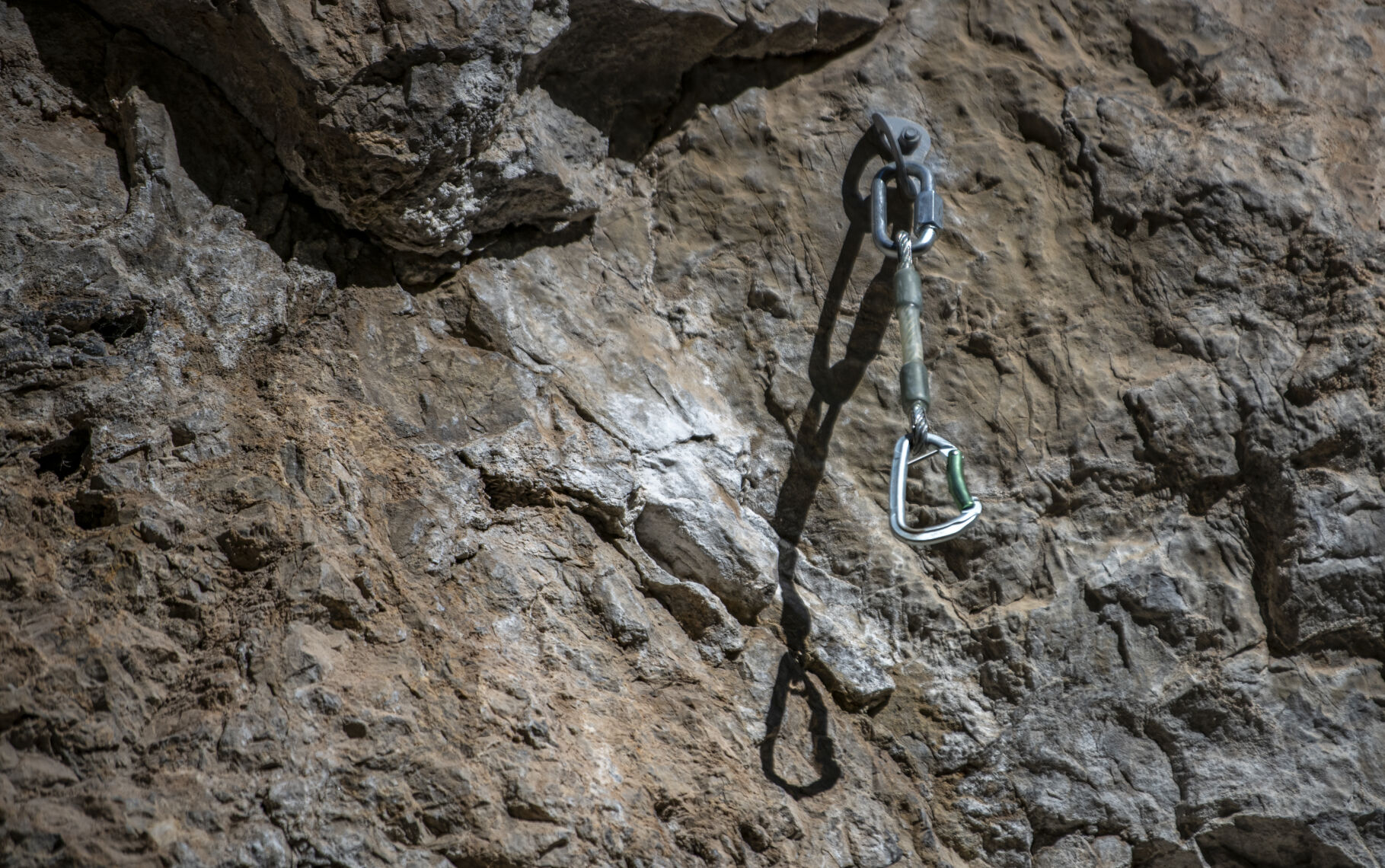 A carabiner is hooked into a bolted anchor on one of the climbing routes at Rifle Mountain Park. (Gabi Broekema, the gazette)