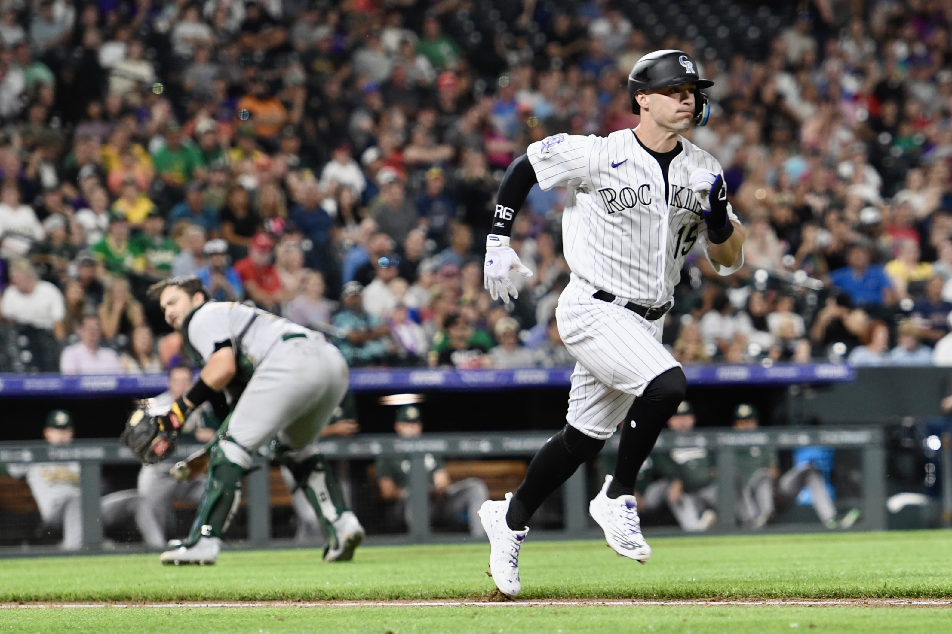 Rockies outfielder Randal Grichuk tries to outrun a throw against the Oakland Athletics on Friday, July 28, 2023. (CarsonFieldcarson.field@gazette.comhttps://secure.gravatar.com/avatar/c524ef3d384945349bed78d70eb2d2cd?d=mm&r=g)