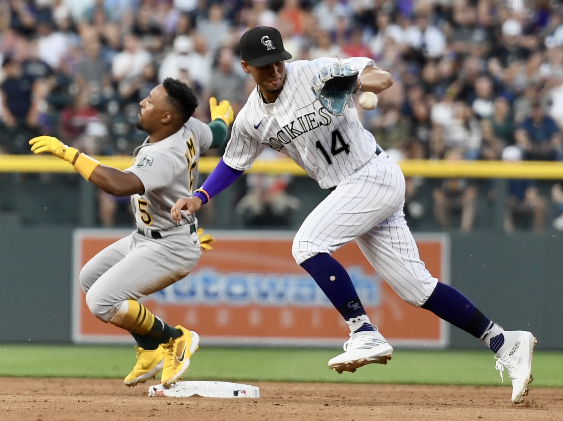 Rockies shortstop Ezequiel Tovar fields a ball as Athletics outfielder Tony Kemp reaches second base safely on Friday, July 28, 2023. (CarsonFieldcarson.field@gazette.comhttps://secure.gravatar.com/avatar/c524ef3d384945349bed78d70eb2d2cd?d=mm&r=g)