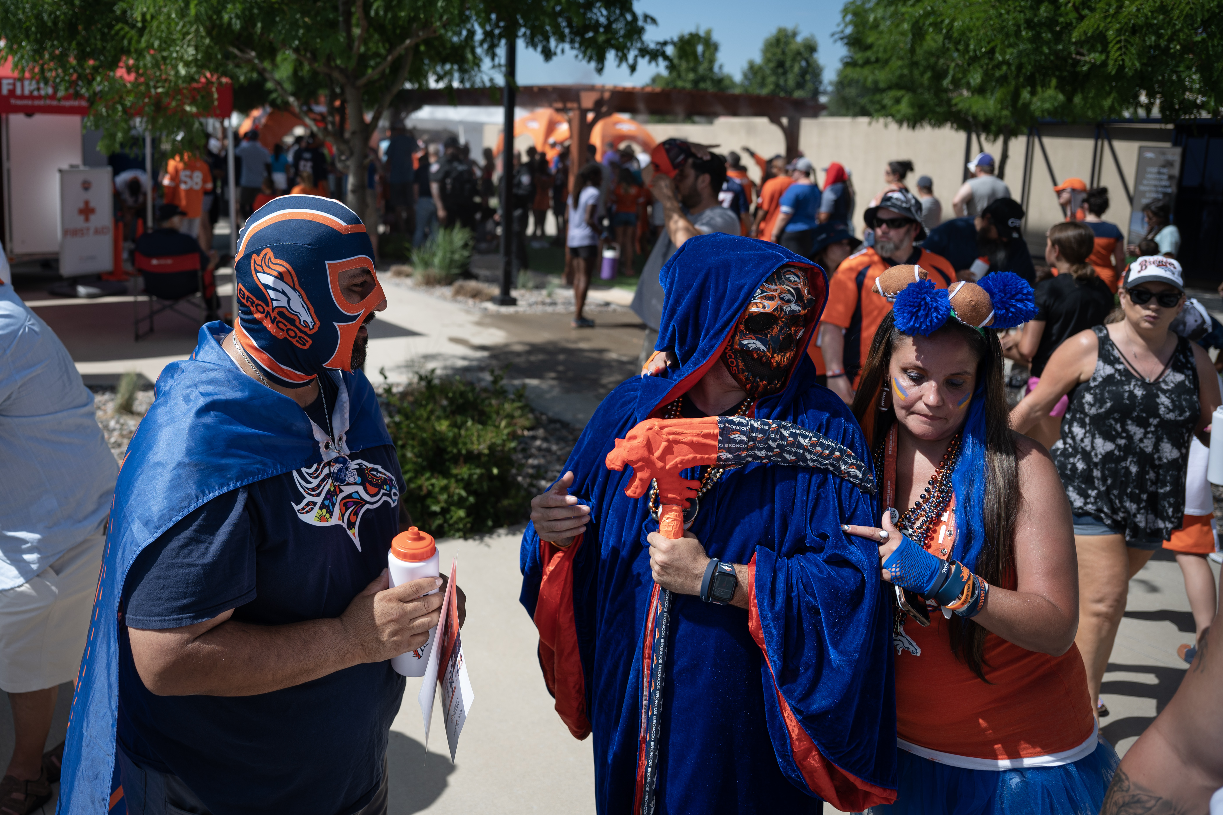 Denver Broncos fans, from left, Elias “Bronco Libre” Balderrama, Jesse “Bronco Reaper” Esquibel and Missy “Mile High Missy” Hamilton converse during training camp on Friday, July 28, 2023, at the Centura Health Training Center in Centennial, Colo. (Timothy Hurst/Denver Gazette) (TimHursttim.hurst@gazette.comhttps://secure.gravatar.com/avatar/aca82bd62b4ee425c598527cd6faa1b1?d=mm&r=g)