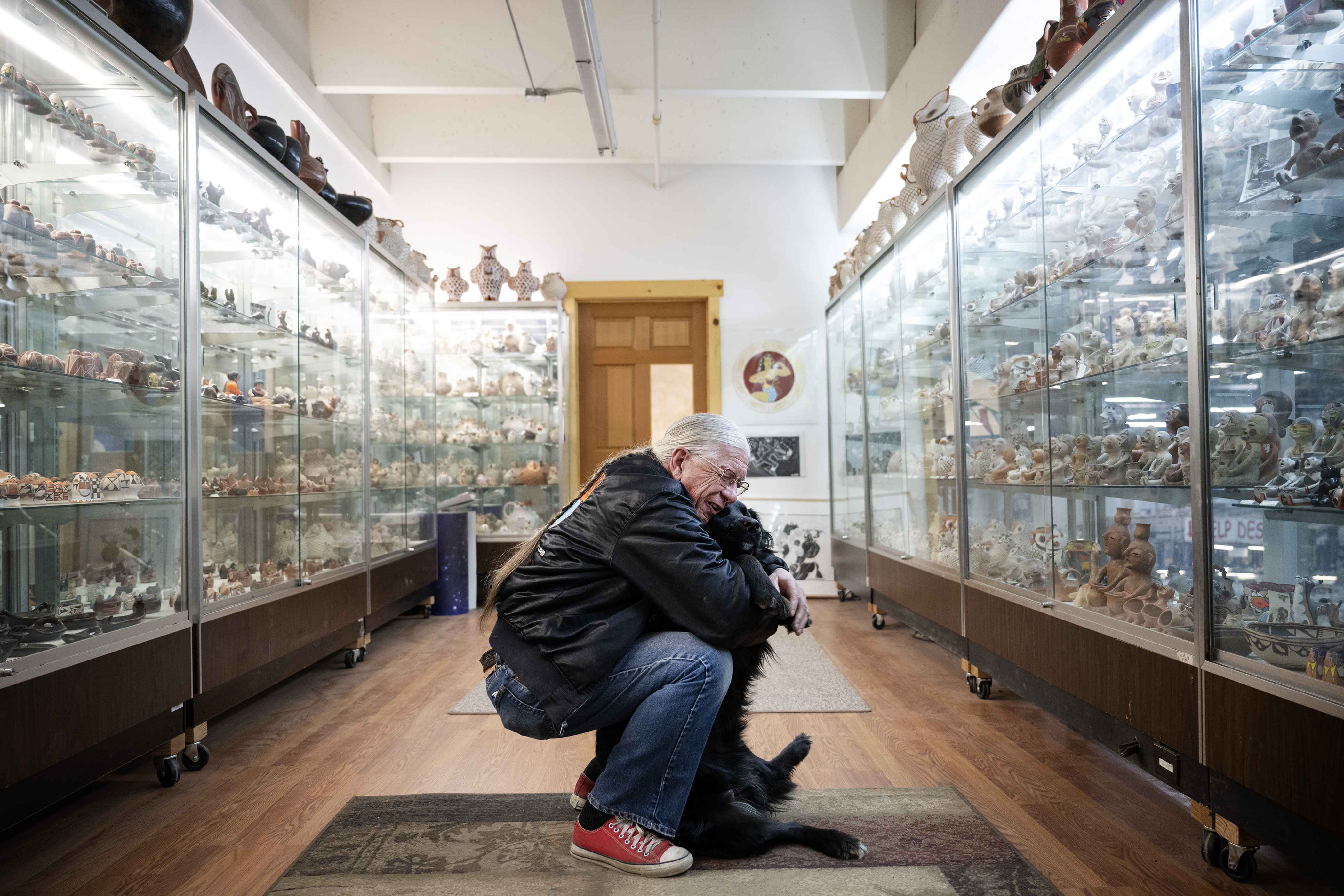 President and founder Chuck Rozanski hugs his dog Nicky in the upper office area where Rozanski’s collection of southwestern pottery is displayed on Saturday, Feb. 11, 2023, at the Mile High Comics Jason Street Mega Store in Denver, Colo. (Timothy Hurst/Denver Gazette) (TimHursttim.hurst@gazette.comhttps://secure.gravatar.com/avatar/aca82bd62b4ee425c598527cd6faa1b1?d=mm&r=g)
