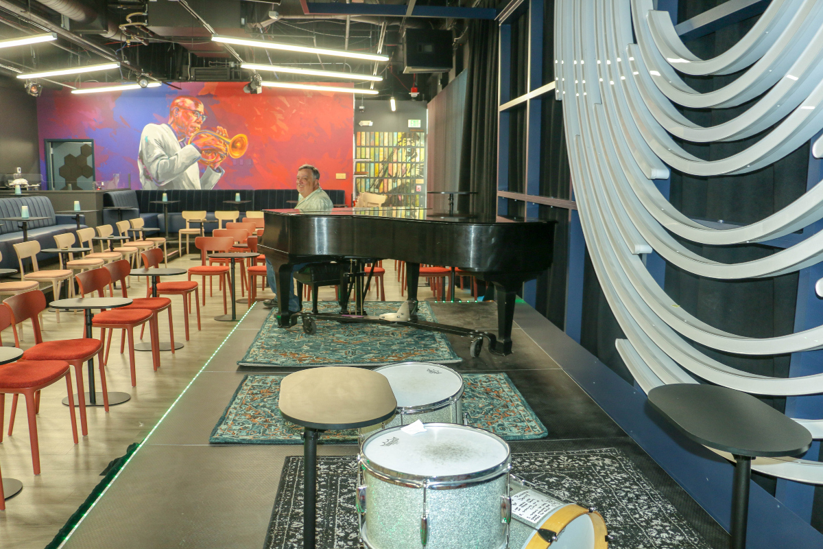 Owner Donald Rossa sits at the piano inside the new Dazzle jazz club, which opens Aug. 4, 2023, in its new location at 14th and Arapahoe streets in the Denver Performing Arts Complex. (John Moore, The Denver Gazette)