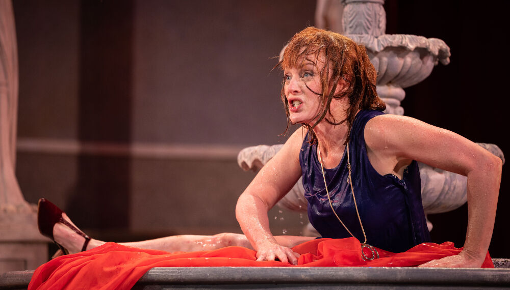 Jessica Robblee gets wet as Beatrice in the Colorado Shakespeare Festival's 'Much Ado About Nothing' – but not because of any summer rains. Its for comic effect thanks to a set designed by Kevin Nelson. (Jamie Kraus)