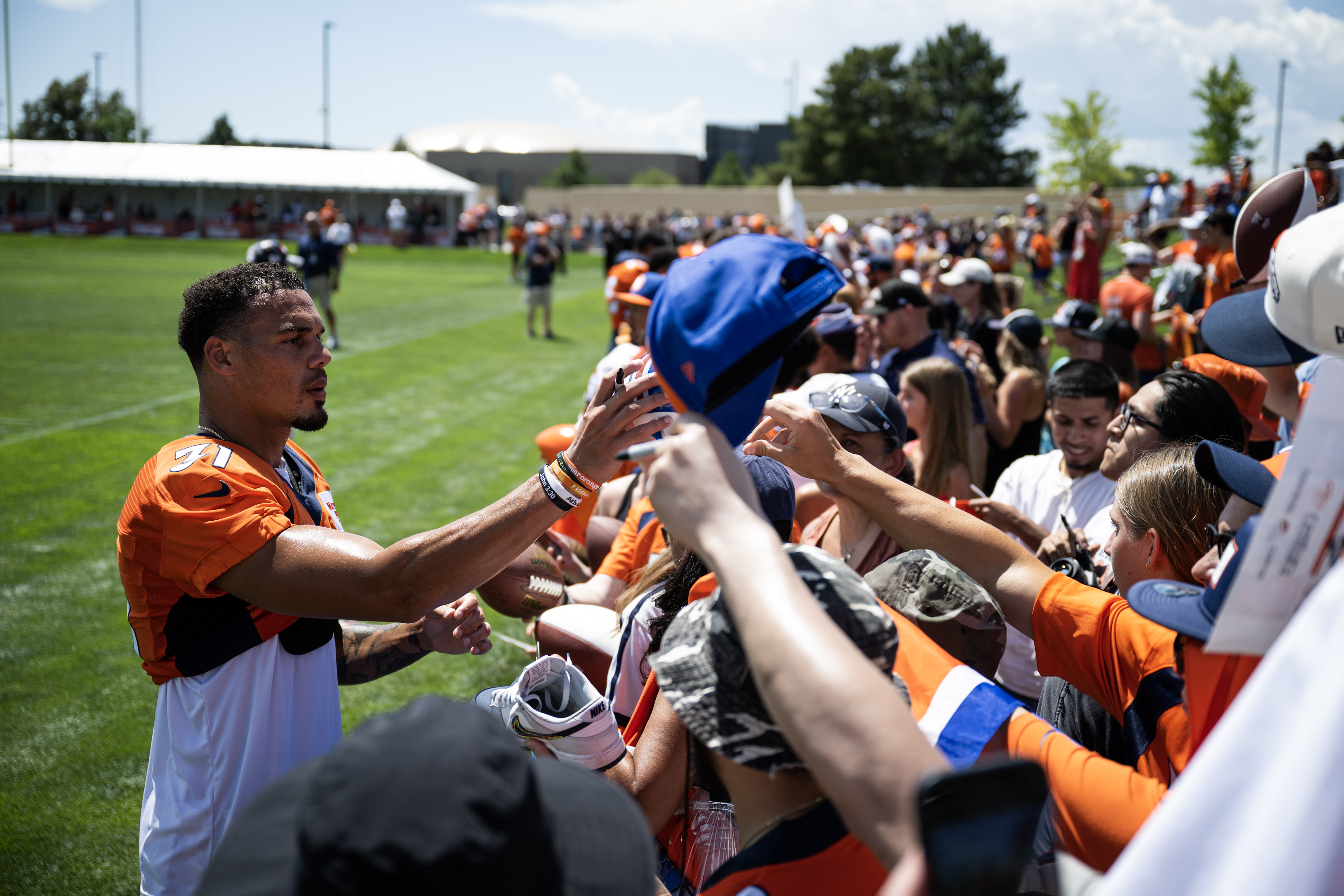 Denver Broncos safety Justin Simmons (31) signs autographs for fans after training camp on Friday, July 28, 2023, at the Centura Health Training Center in Centennial, Colo. (Timothy Hurst/Denver Gazette) (TimHursttim.hurst@gazette.comhttps://secure.gravatar.com/avatar/aca82bd62b4ee425c598527cd6faa1b1?d=mm&r=g)