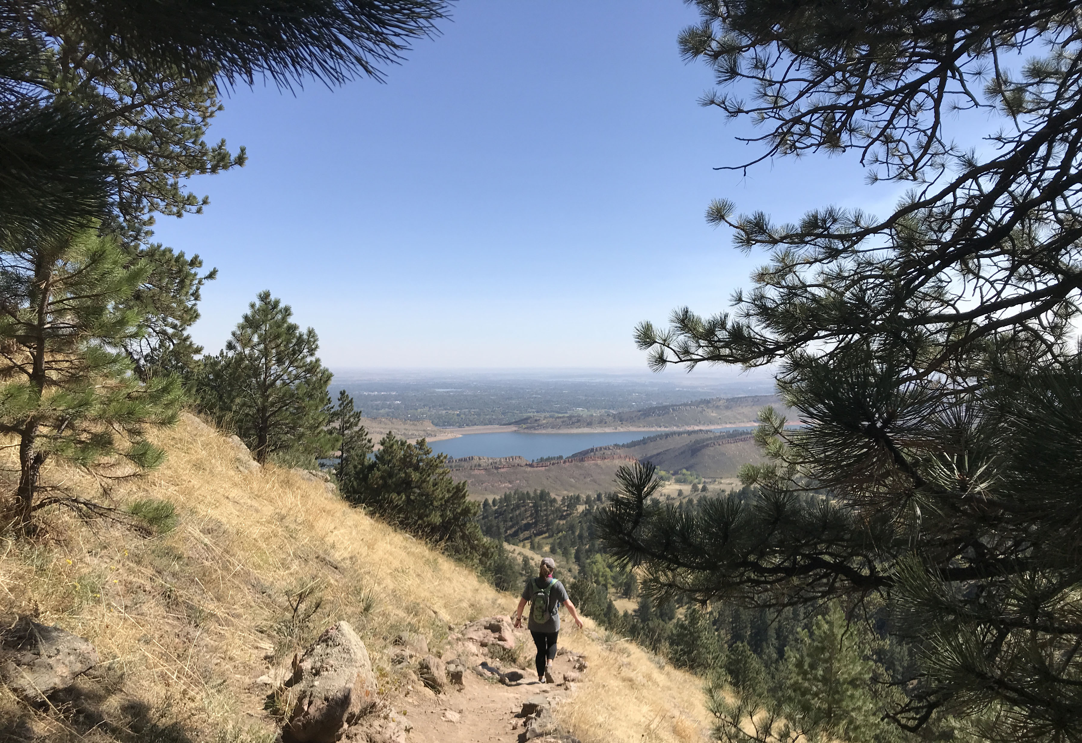 A hiker descends the Arthur’s Rock trail at Lory State Park, with views of Horsetooth Reservoir and the plains beyond Fort Collins. Photo by Seth Boster, The Gazette