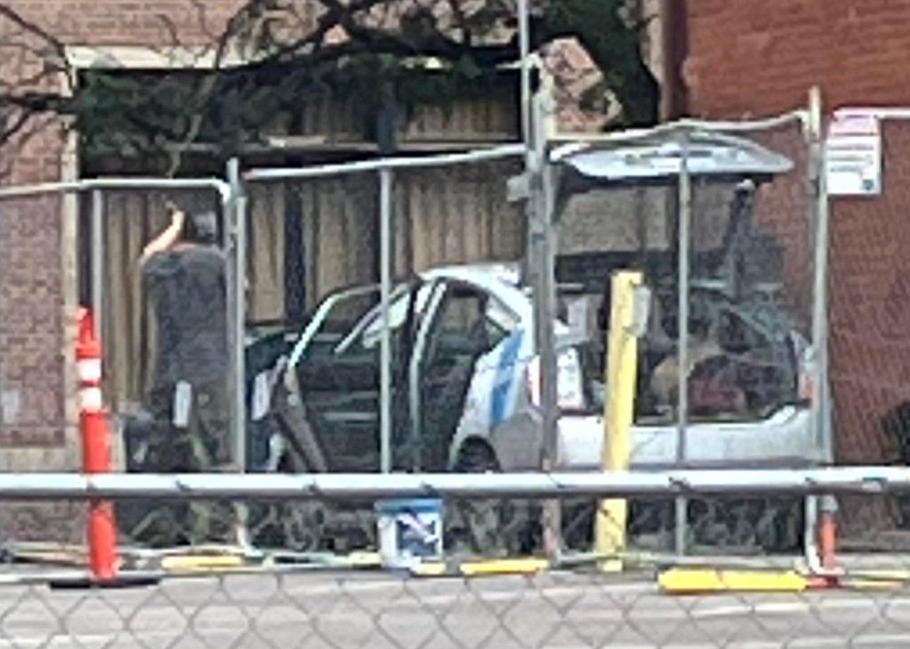 A video taken by a passerby captured an unidentified man who appeared to be aiming at an upscale high rise The Beauvallon at 925 Lincoln Ave. on the afternoon of July 4. The doors and trunk of the Prius he was driving are open. After he allegedly shot the .22 rifle, the man sped away, according to the bystander, who did not want to be identified. (Screen grab from video posted by YouTube user @Jmach_)