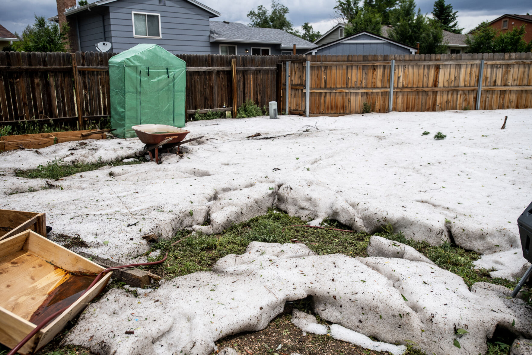 Hail piled in a backyard in Colorado Springs looks like snow in mid-June. (Parker Seibold, the gazette)