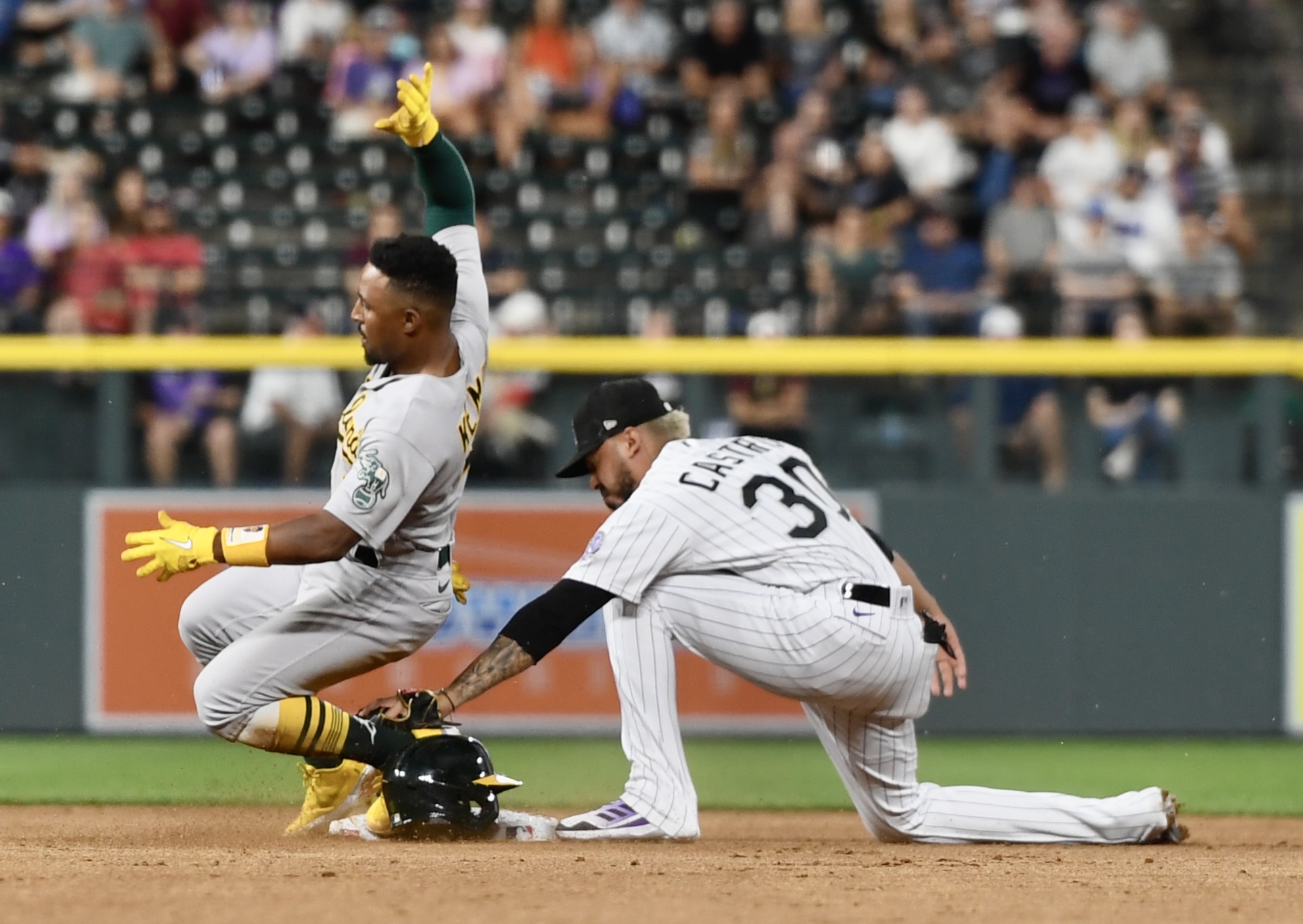 A's outfielder Tony Kemp beats a tag from Harold Castro at second base on Friday, July 28, 2023. (CarsonFieldcarson.field@gazette.comhttps://secure.gravatar.com/avatar/c524ef3d384945349bed78d70eb2d2cd?d=mm&r=g)